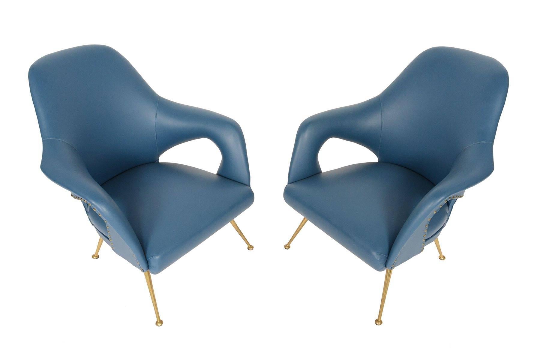 This pair of Italian modern lounge chairs was designed with organic forms in mind. Arms extend from the backrest to the seat for a continuous form. Cut-outs beneath the arms provide a light, airy effect and a stunning Silhouette from any direction.