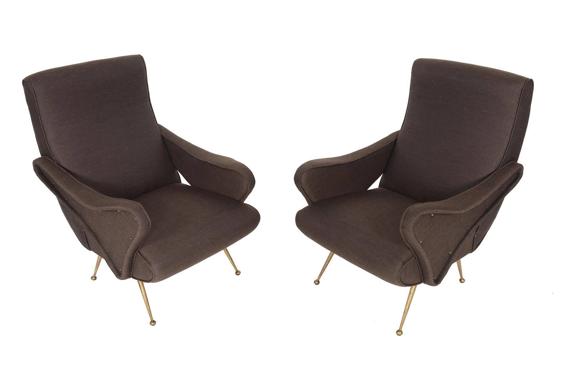 This pair of Italian modern lounge chairs was designed in the 1960s in the style of Marco Zanuso. With lines that reflect an interest in futurism, speed, and technology, the form of this chair is a true modern design. The organic cushions are