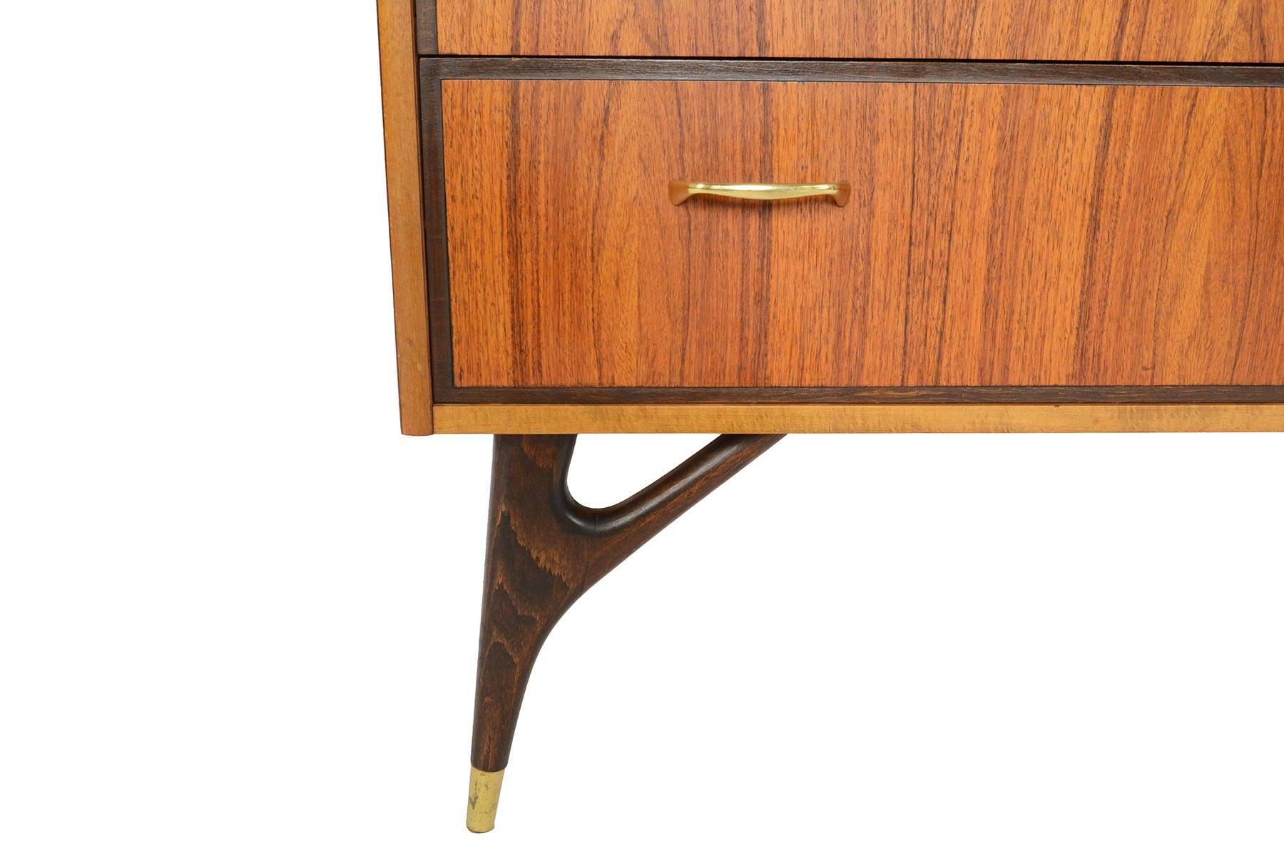 This Swedish modern midcentury three-drawer gentleman's chest in rosewood and oak is a wonderful storage piece with atomic appeal! The rosewood case houses three drawers, each adorned with two brass pulls. The case stands on beautifully sculpted