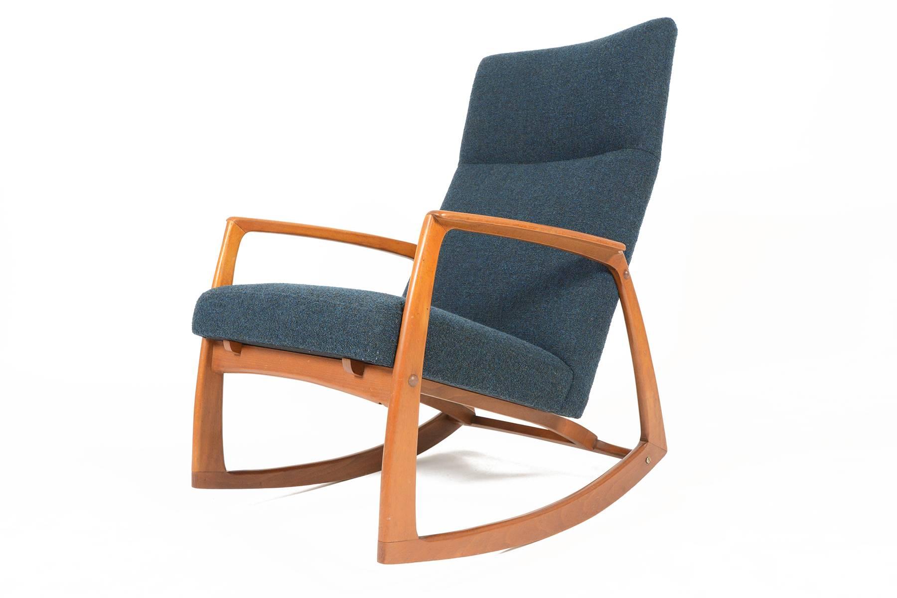 This Danish modern rocking chair is the perfect size for any modern nursery or living room. Crafted from solid teak, the frame features beautifully sculpted joinery. Recently upholstered in nubby aegean blue Danish Kvadrat Outback wool. The frame is
