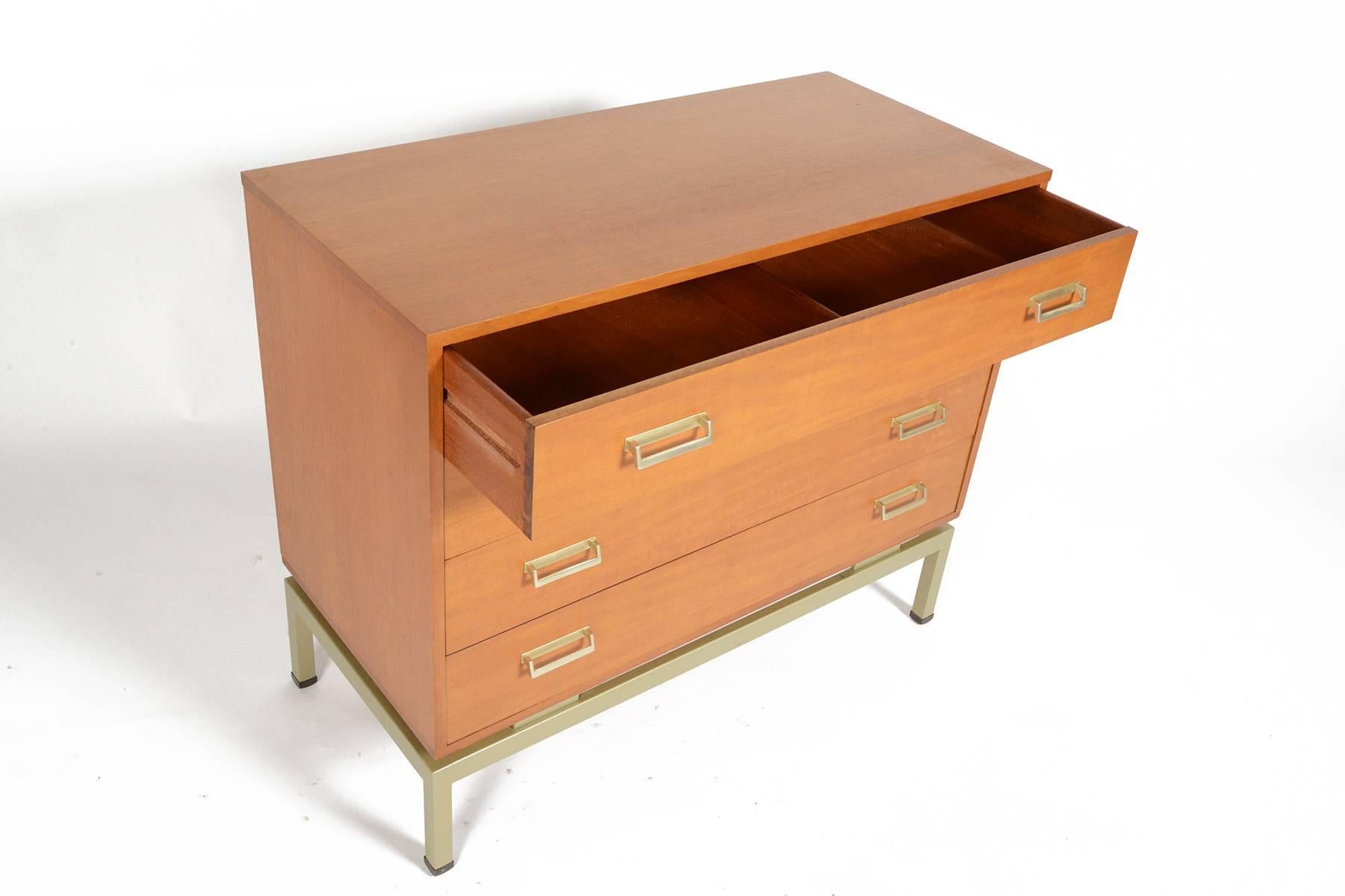 This modern mid century teak gentleman's chest was manufactured by G Plan and offers four nicely sized drawers. Each drawer front features two aluminum pulls. The case is supported by a structural aluminum base. In excellent original condition with