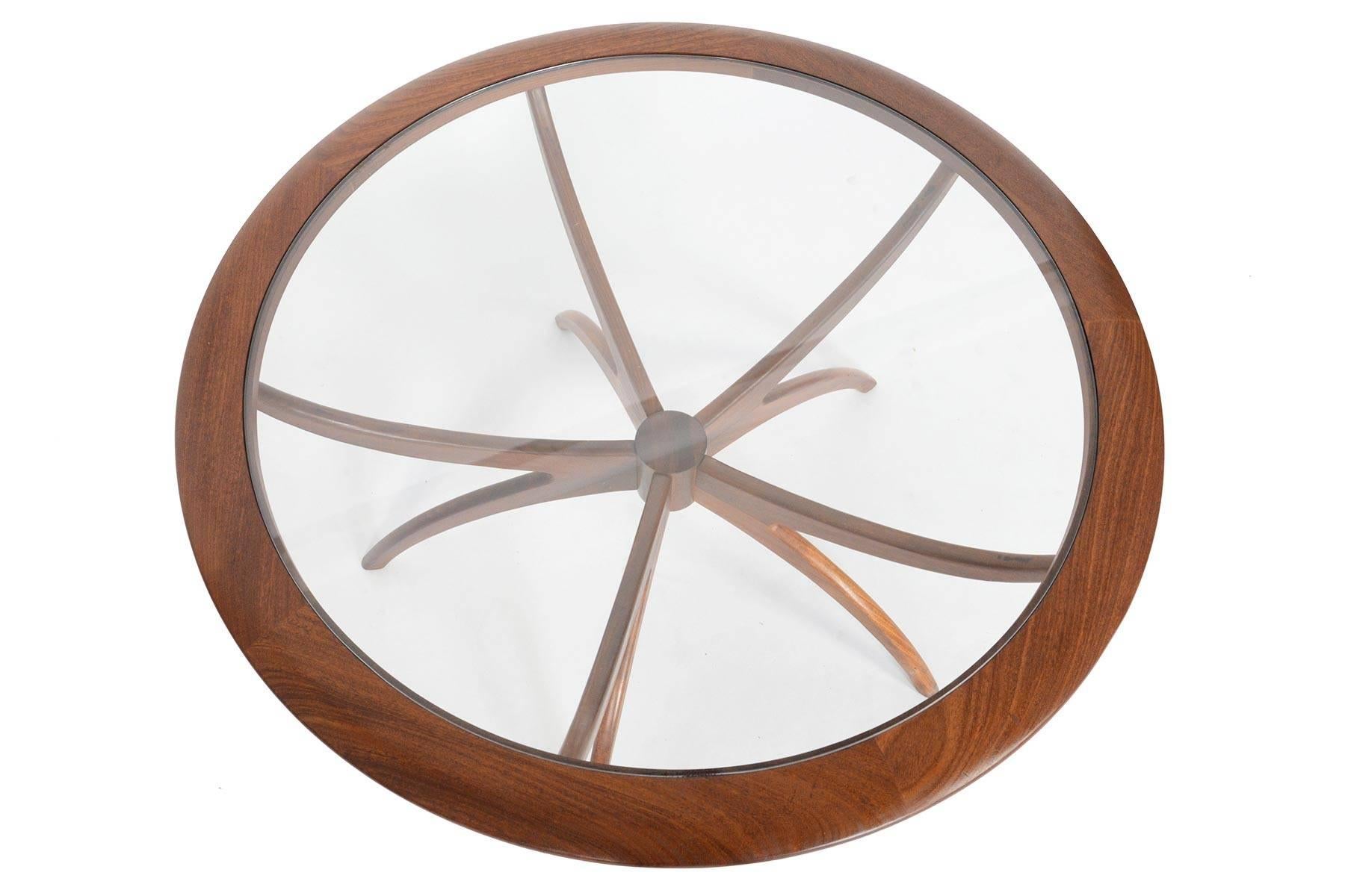 This Mid-Century Modern spider coffee table in afromosia and glass is a rare find. Designed by Victor Wilkins and manufactured by G Plan, this piece is perfect for entertaining and is sure to impress your company. In excellent original condition