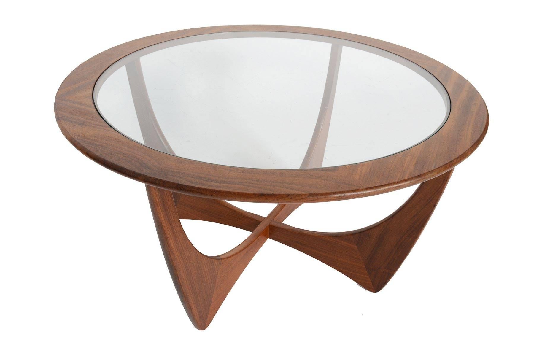 This iconic Mid-Century Modern round afromosia and glass coffee table was designed by Victor Wilkins for G Plan's Astro range in the 1960s. Gorgeous design and construction throughout. In excellent original condition with typical wear for its