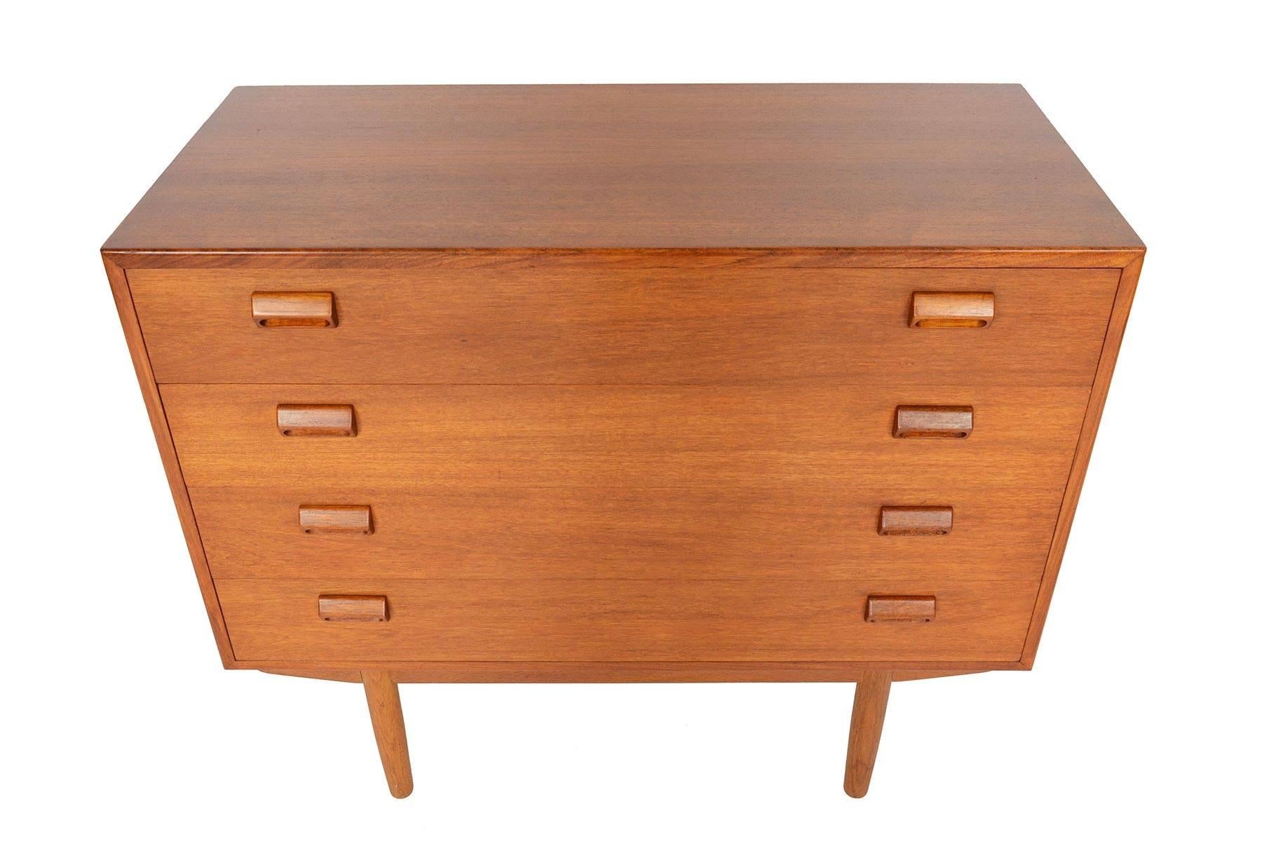 This beautiful gentleman's chest was designed by Børge Mogensen for Søborg Møbelfabrik in 1951. The case is expertly crafted in teak and stands on a solid oak base. Each drawer front is adorned with the designer's signature handles. Four deep