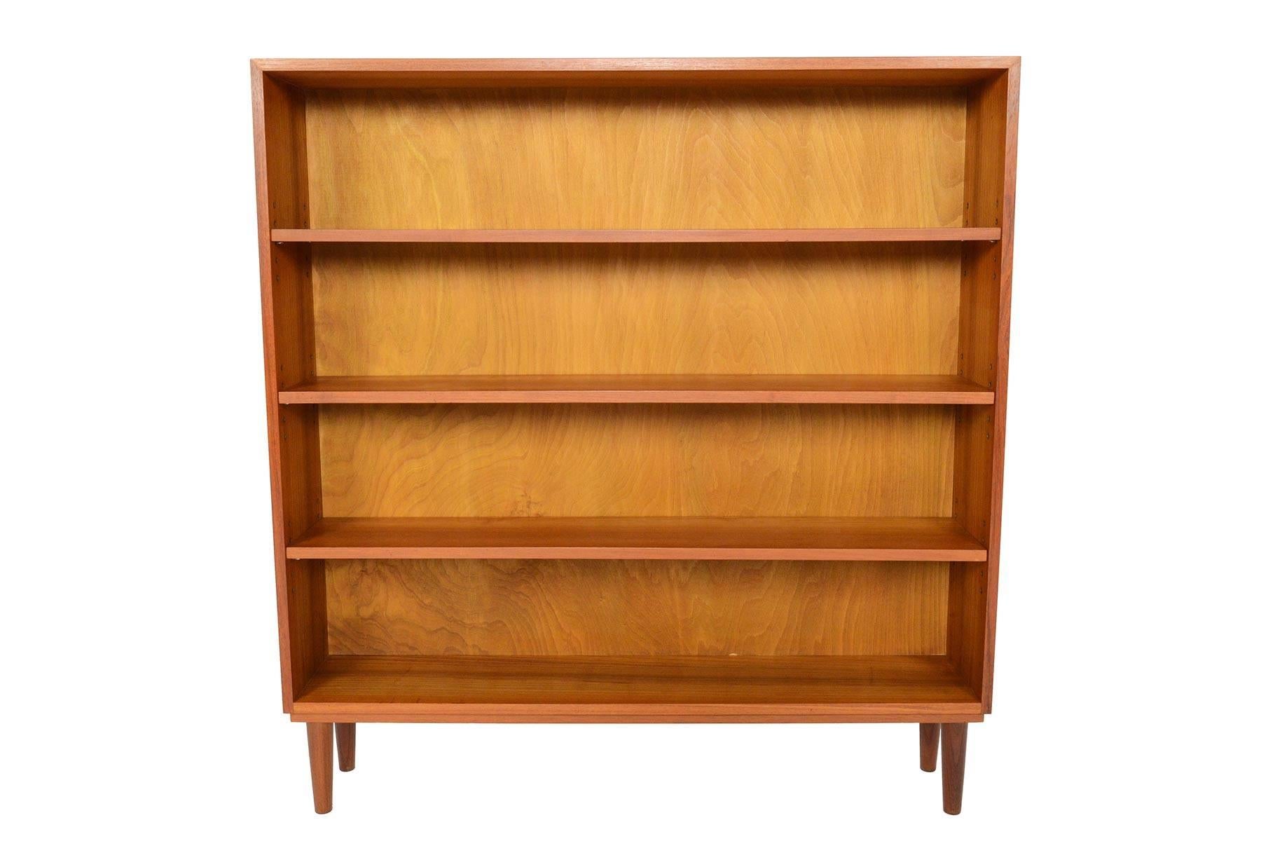 This gorgeous Danish modern midcentury bookcase in teak is the perfect storage piece for any modern home. Three adjustable shelves provide plenty of variation for all storage needs, and the extra narrow depth creates versatility for this piece to be