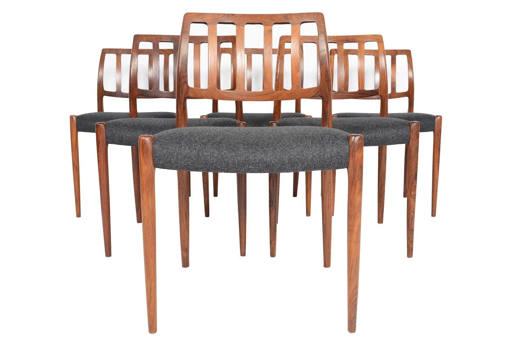 This beautiful set of six model 83 rosewood dining chairs was designed by Niels Otto Møller for J.L. Møllers Møbelfabrik ion 1974. Crafted in solid rosewood, each frame features rich and active woodgrain with a focus of ergonomics and sturdy