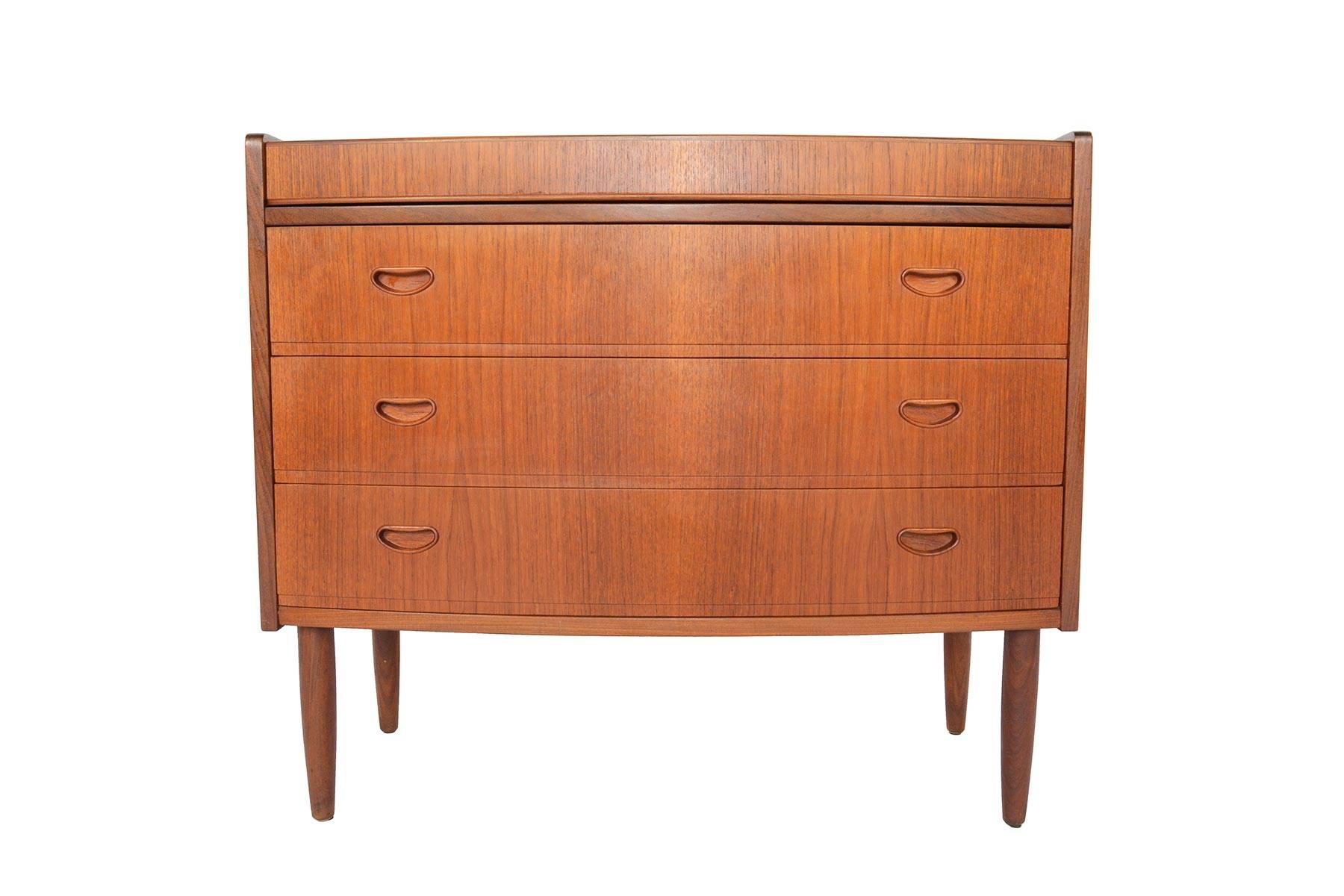 This gorgeous flip top Danish modern secretary desk or vanity will work beautifully in any modern bedroom or entry. Crafted in teak, this well built piece easily converts from a small gentleman's chest to a full vanity in seconds. When opened, three