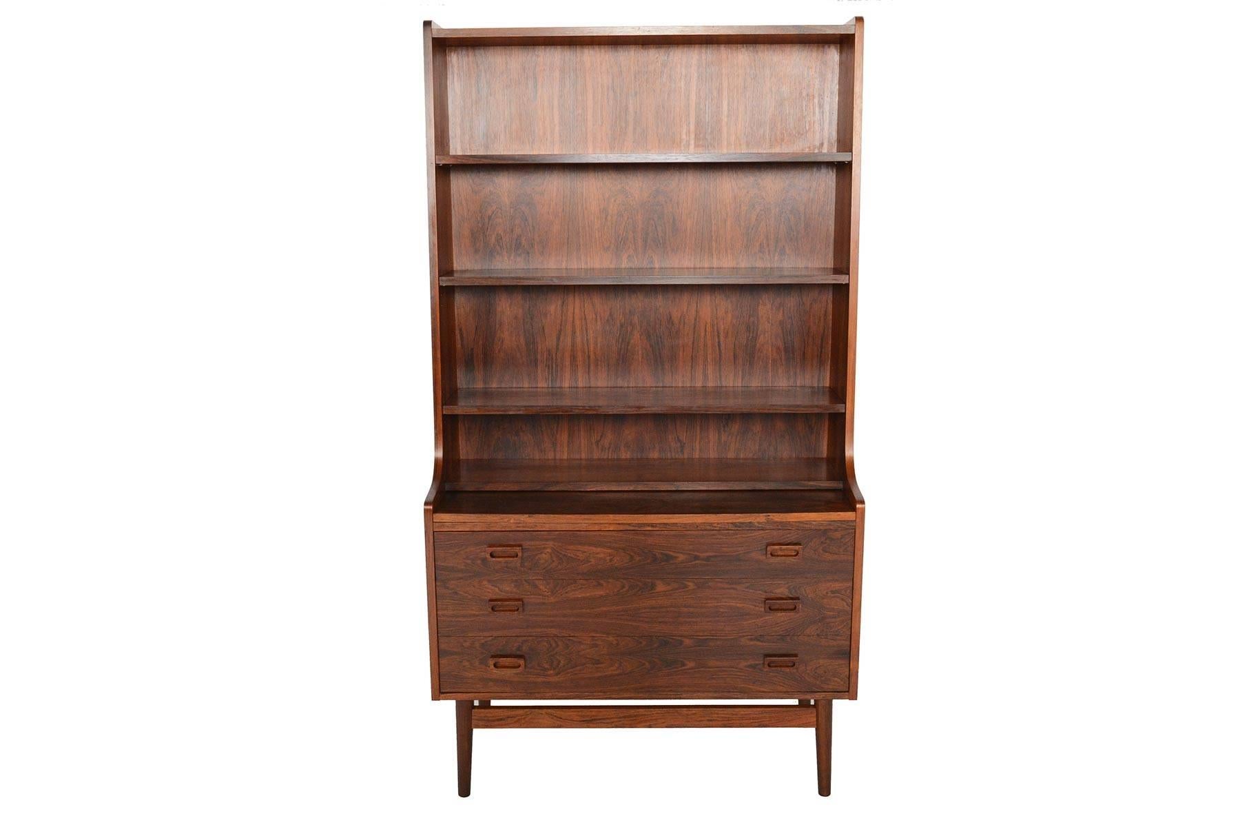 This beautiful Danish modern midcentury bookcase in Brazilian rosewood was designed by Johannes Sorth for Bornholm Møbelfabrik, Nexø in the mid 1960s. The tall, upper hutch features three adjustable shelves. The lower cabinet features three large