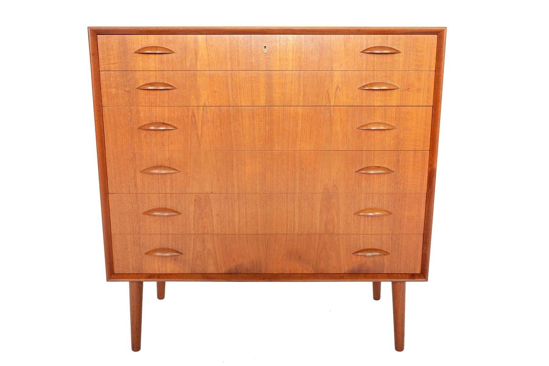 This handsome teak dresser was designed by Johannes Sorth for Nexø Møbelfabrik in the 1960s. Two carved teak pulls adorn each drawer face. With superior craftsmanship throughout, the case features mitered edges and built- in dividers in the top