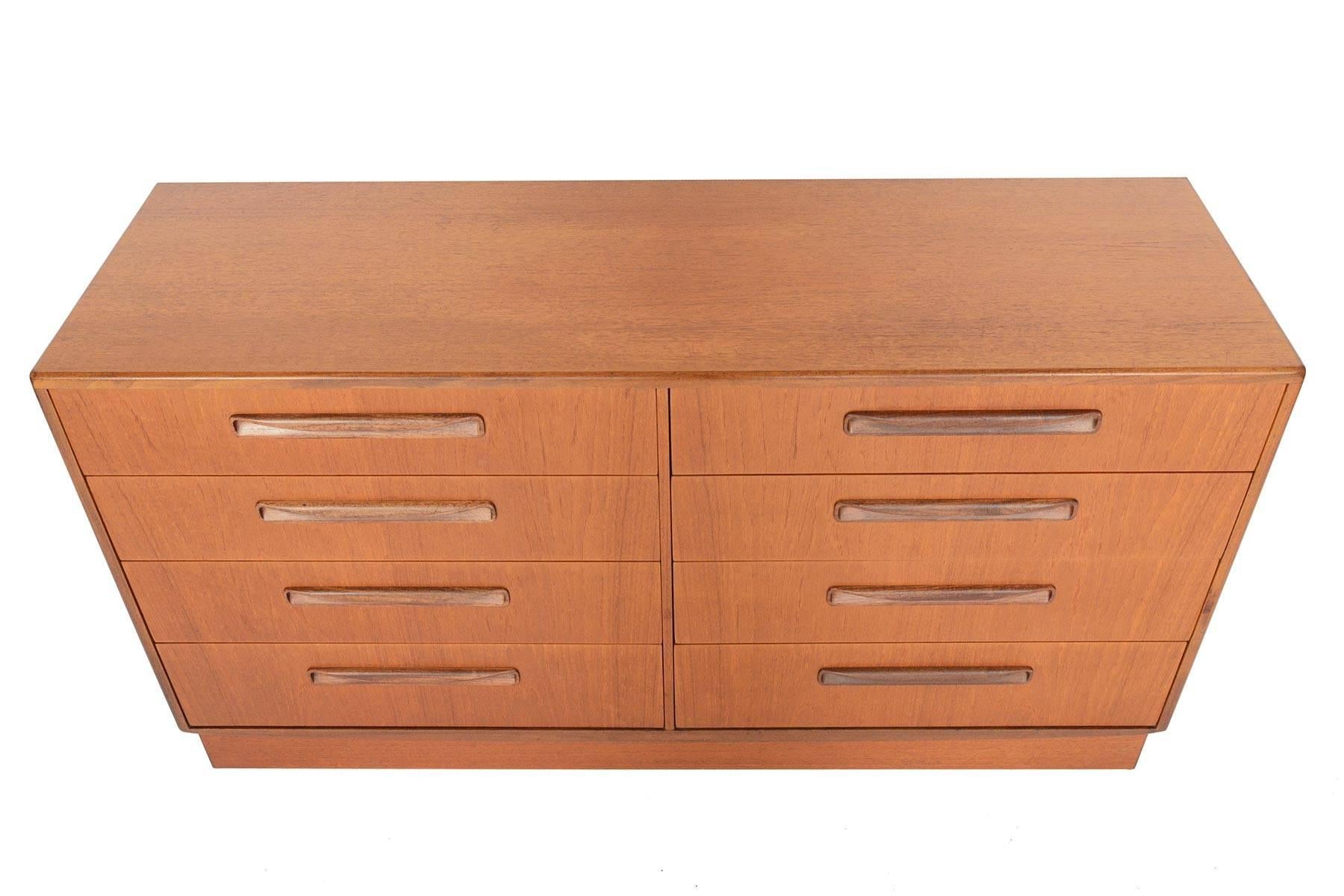 English modern G Plan Fresco double dresser. Designed by Victor Wilkins in the 1960s, this fantastic dresser features eight deep drawers with solid teak drawer fronts carved afromosia pulls. With its low design, this piece is perfect for any space.