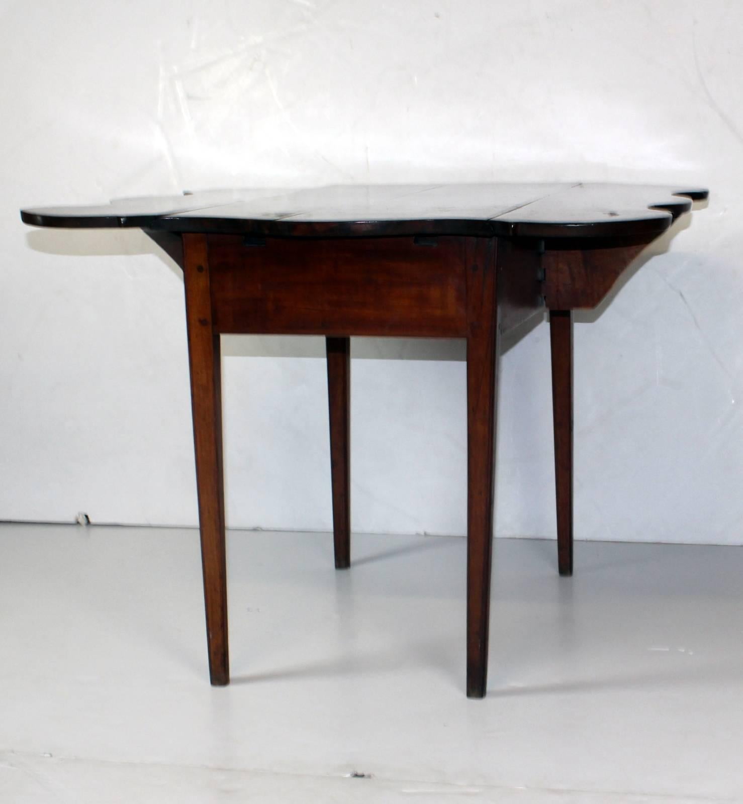 American curly walnut Pembroke table with four tapered legs. Opened 35