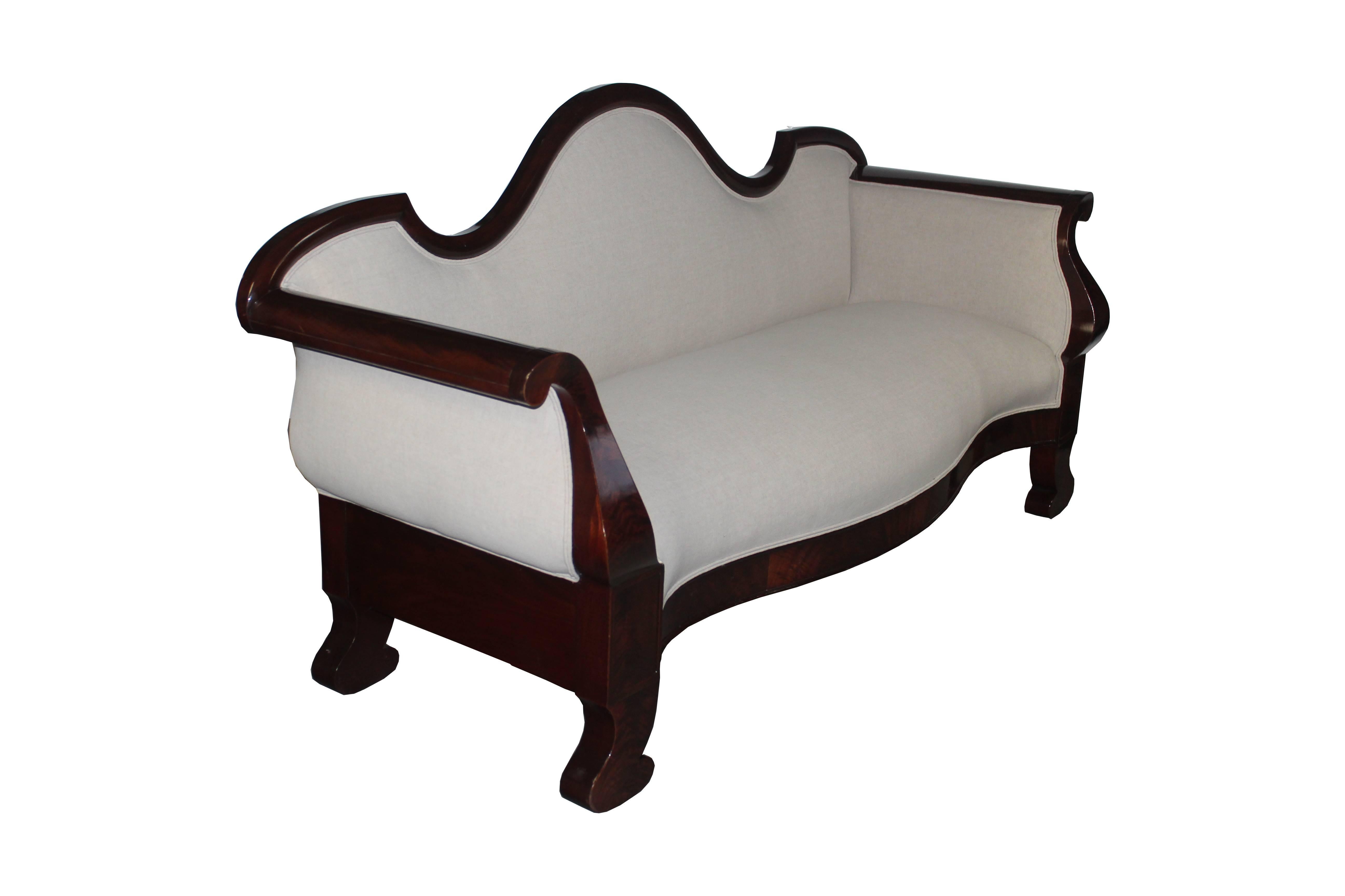 Beautiful 19th century mahogany sofa with plain lines. Upholstered in light gray linen.