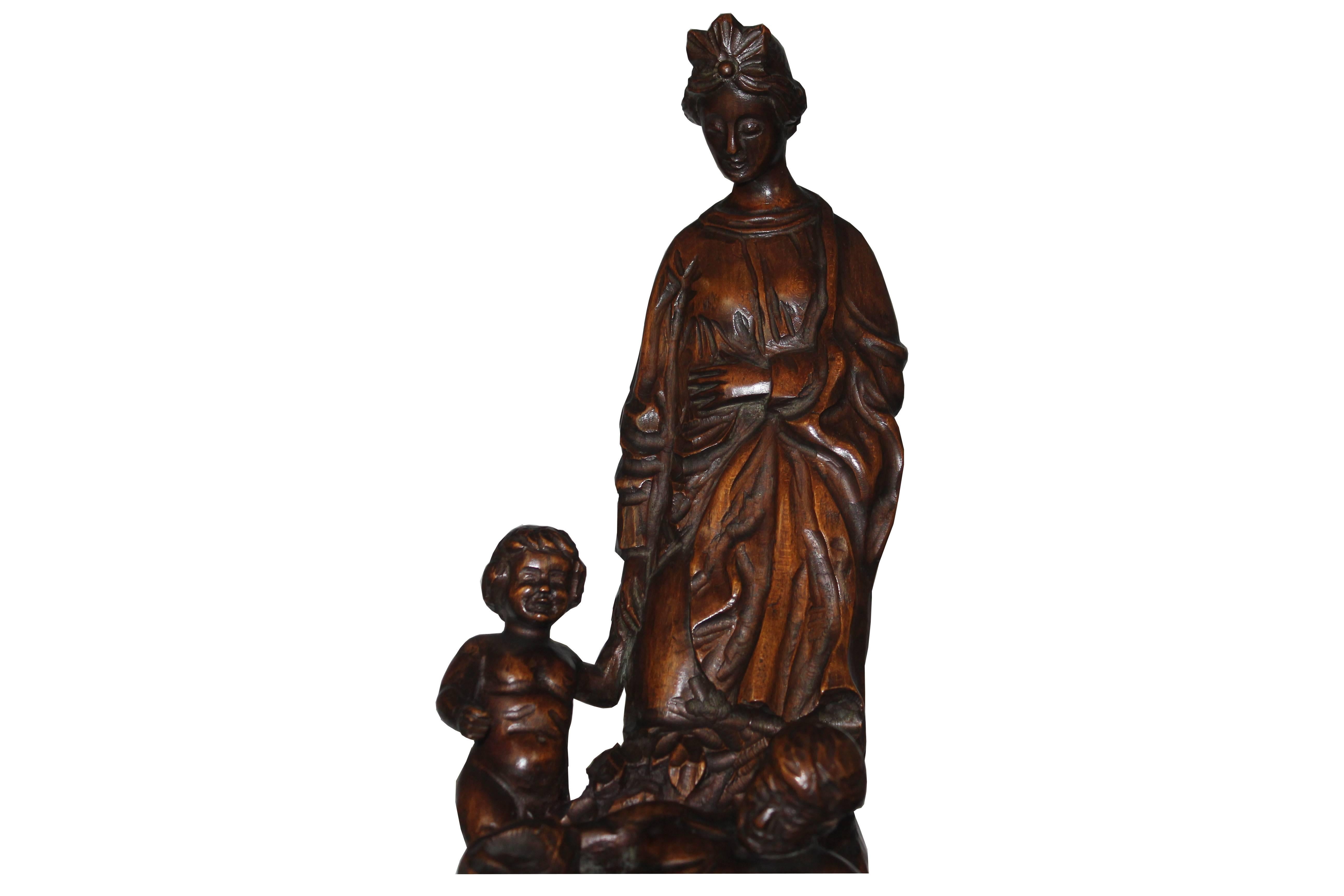 19th century Italian wood carved statue. The carving has a woman, man and a child.