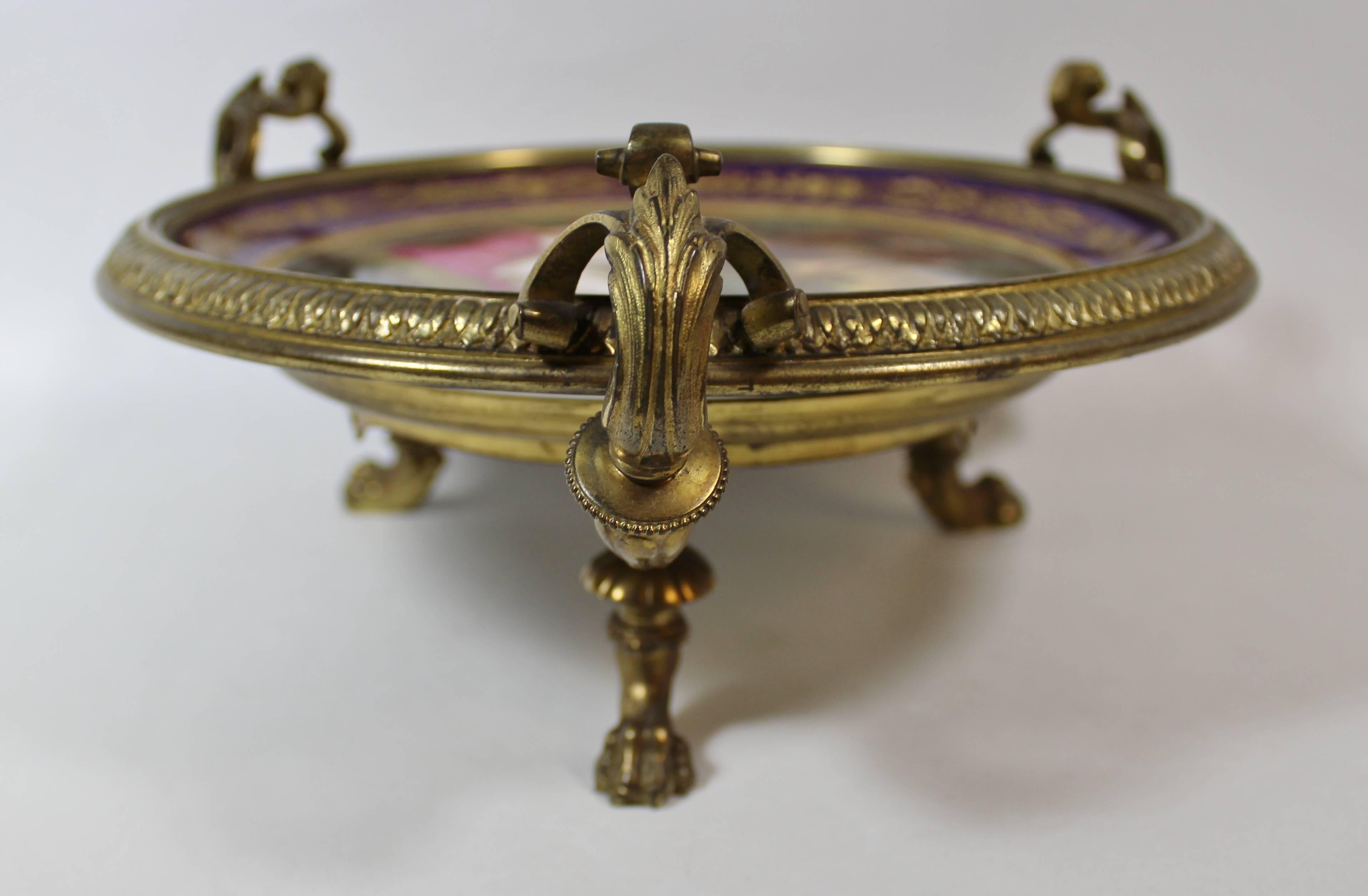 Royal Vienna style hand-painted plate in gilt bronze stand.

It is titled 