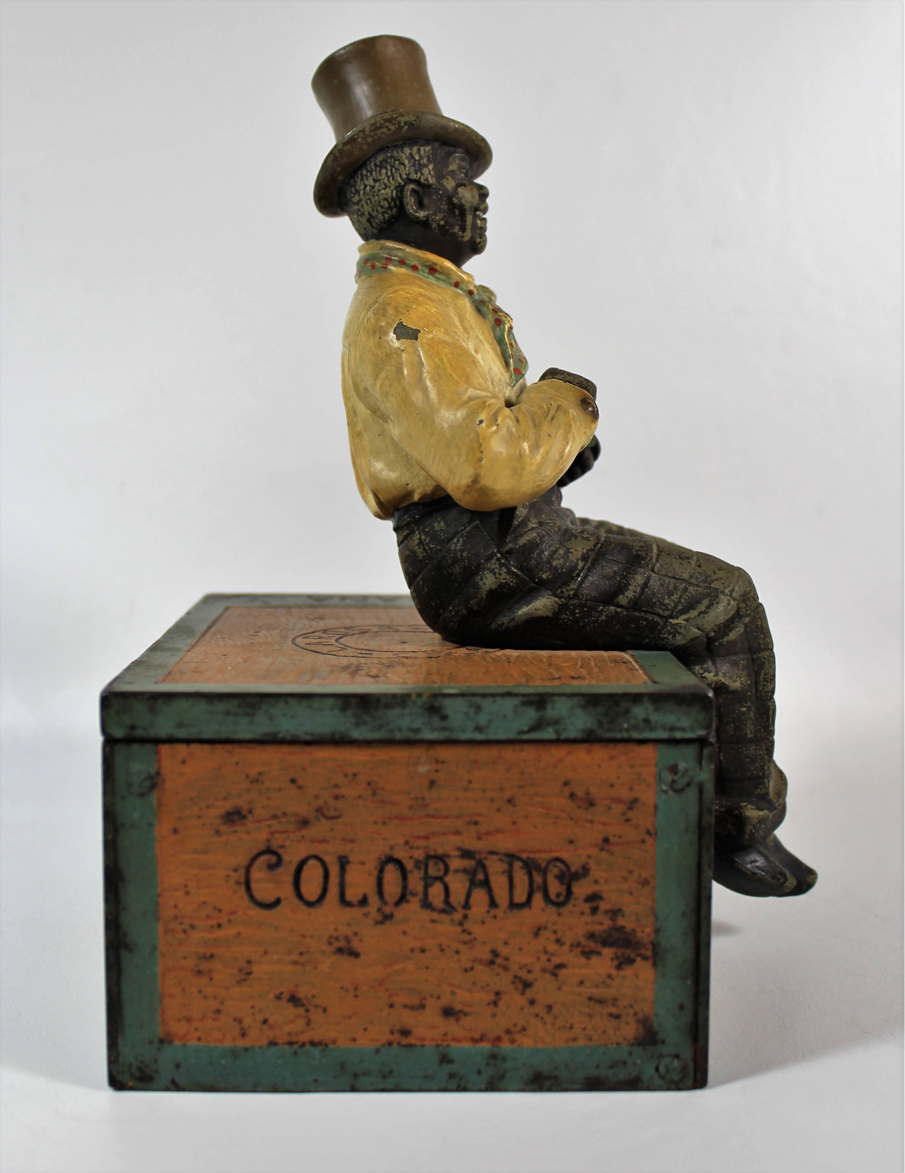 Black Memorabilia Cigar Box/Humidor. Whimsical cast iron humidor with a well dressed black man in a hat and scarf.