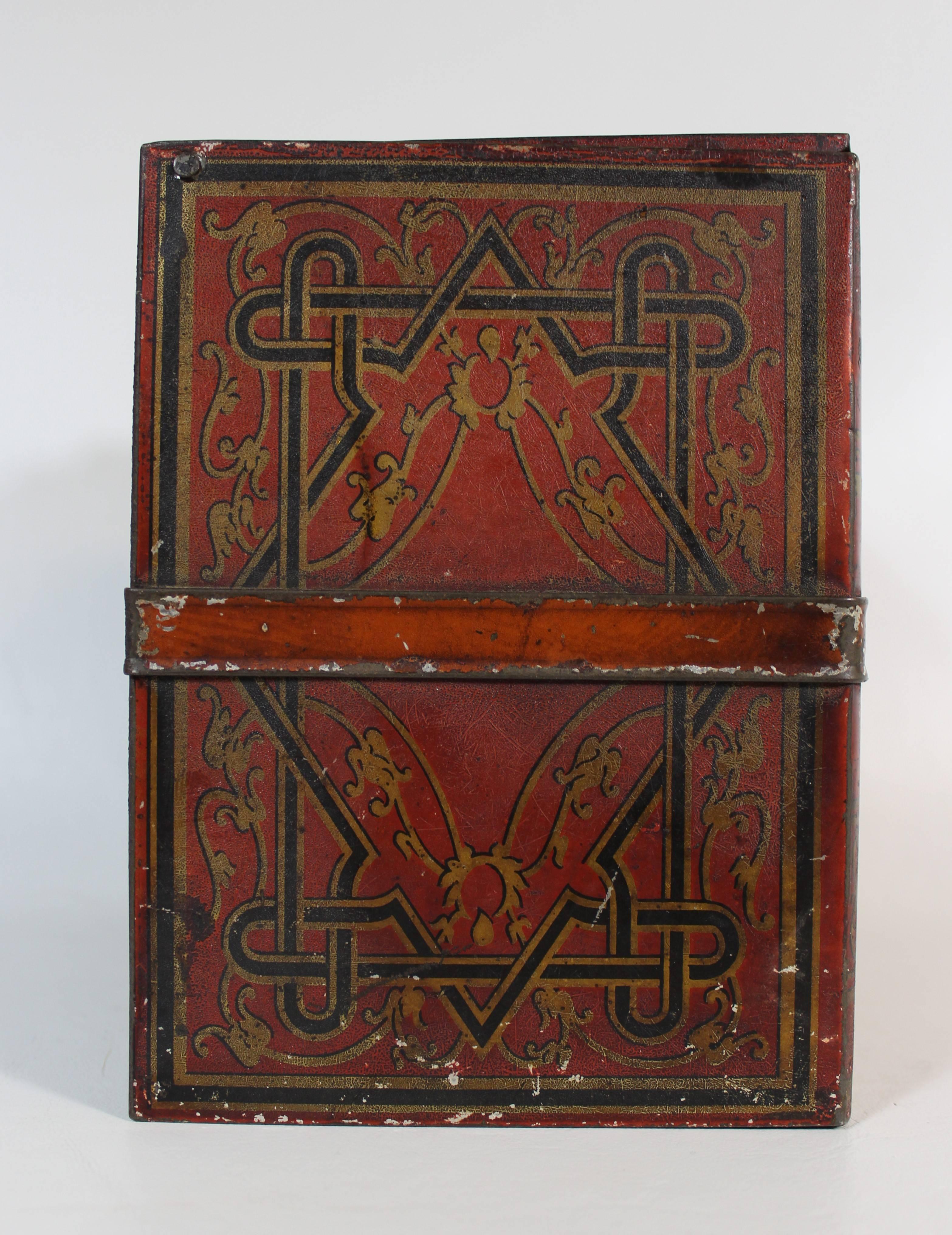 A Huntley & Palmers biscuit tin of the 'Literature' pattern, simulating a bundle of leather bound books. They're held together by a tin leather strap and a pull tab to open the tin box resembles a bookmark.