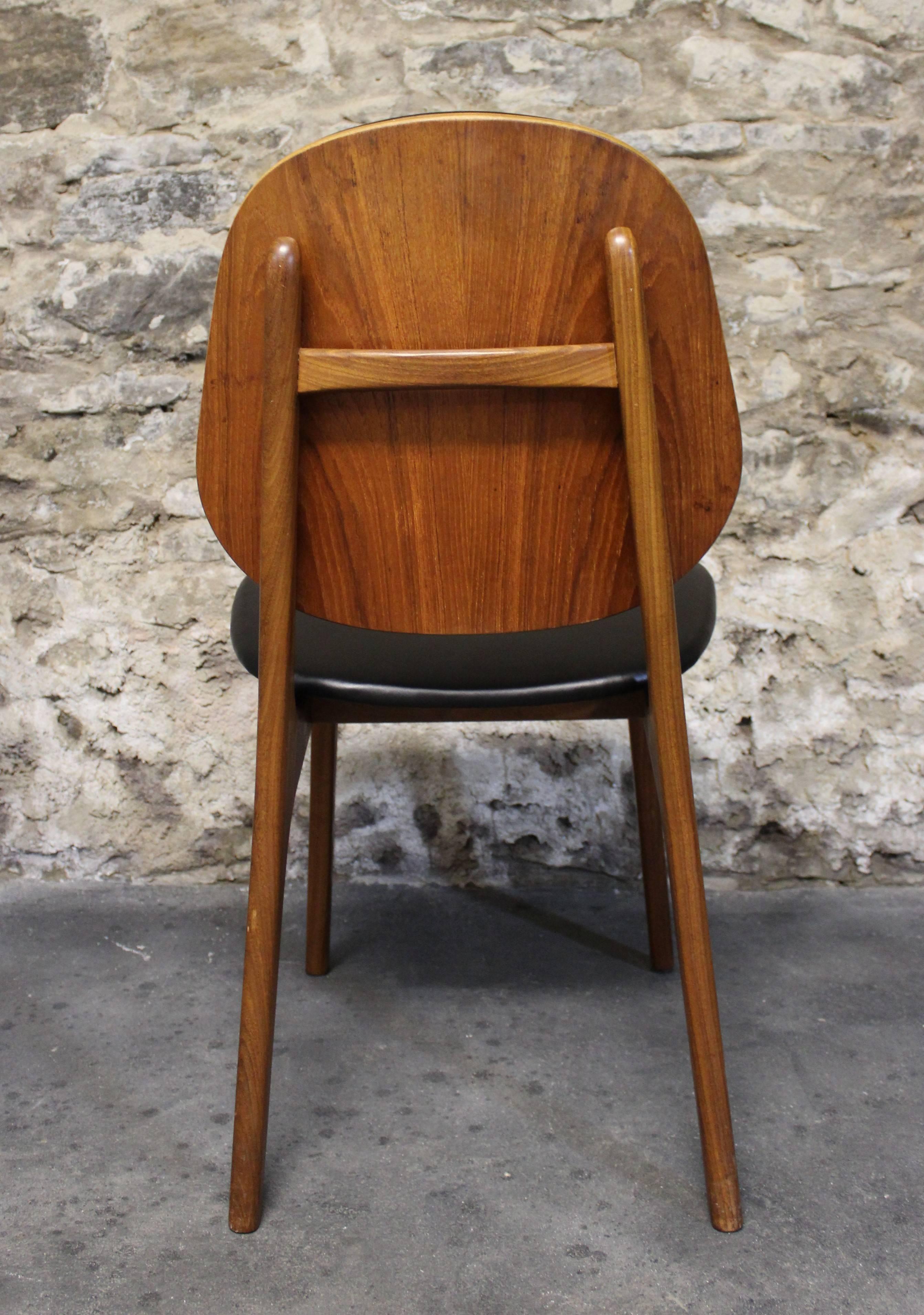 A fantastic set of four Danish teak dining chairs designed by Arne-Hovmand Olsen.