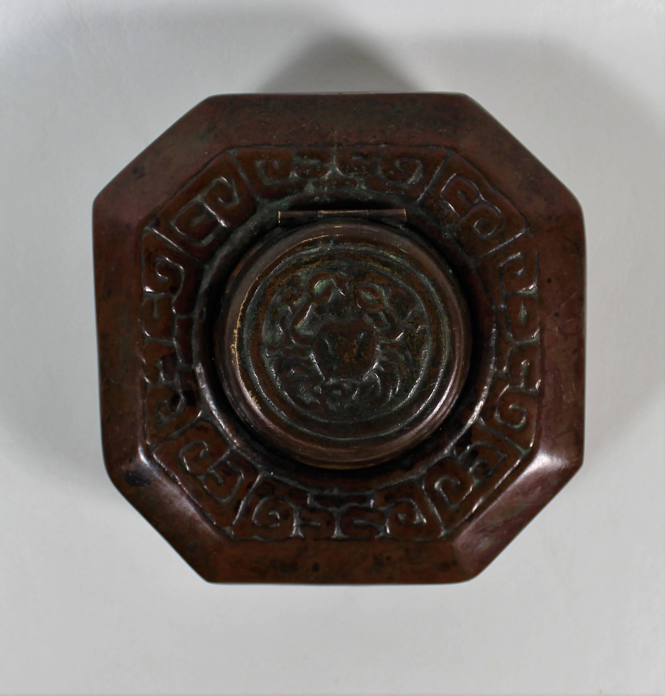 This octagonal shaped inkwell has a round lid opening to a glass insert. It is decorated with the Zodiac pattern with the crab on the lid to symbolize the Cancer sign. The popular zodiac pattern range of desk accessories features rustic, low relief