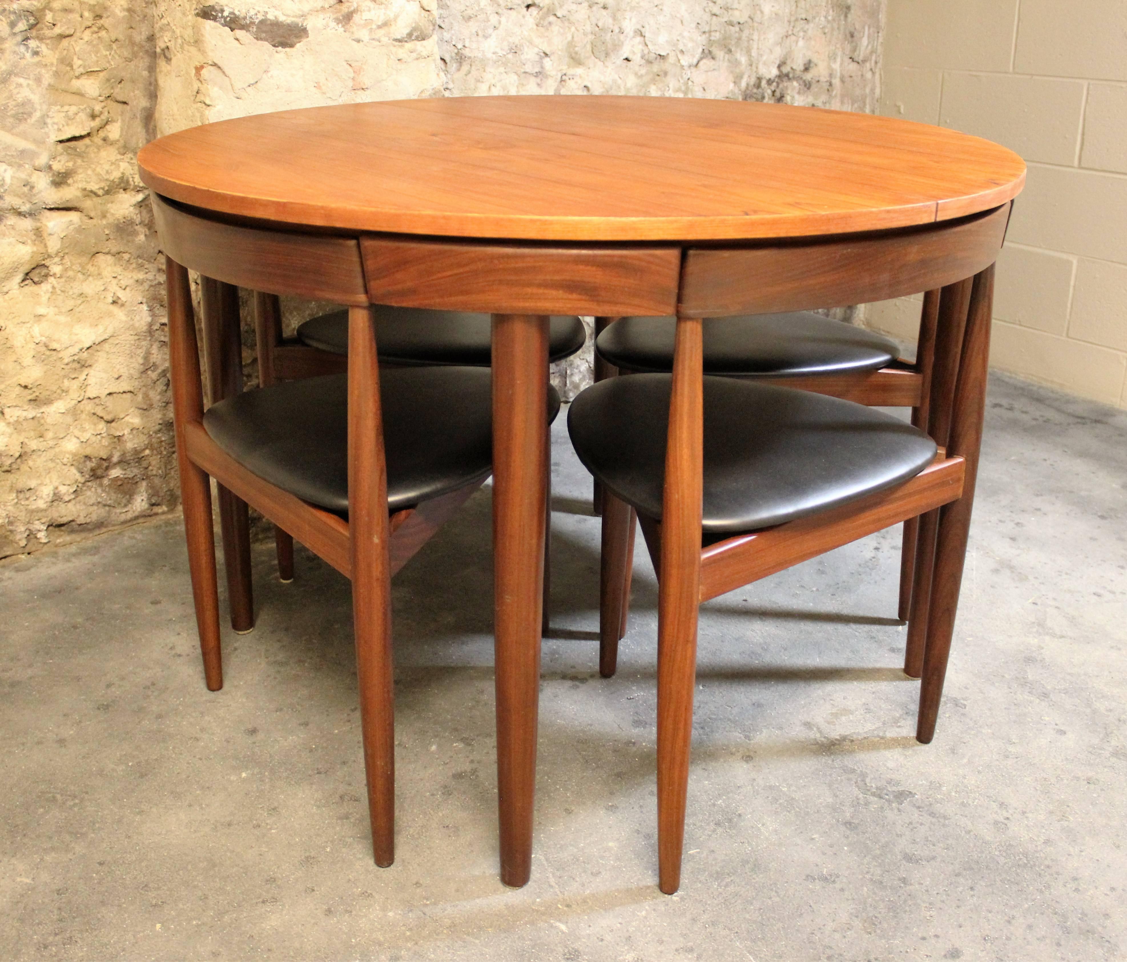 This teak Roundette model dining set, consisting of one extendable dining table and four chairs was designed by Hans Olsen, and manufactured by Frem Rojle in 1952. We also have two additional matching chairs if you would like to make this a set of