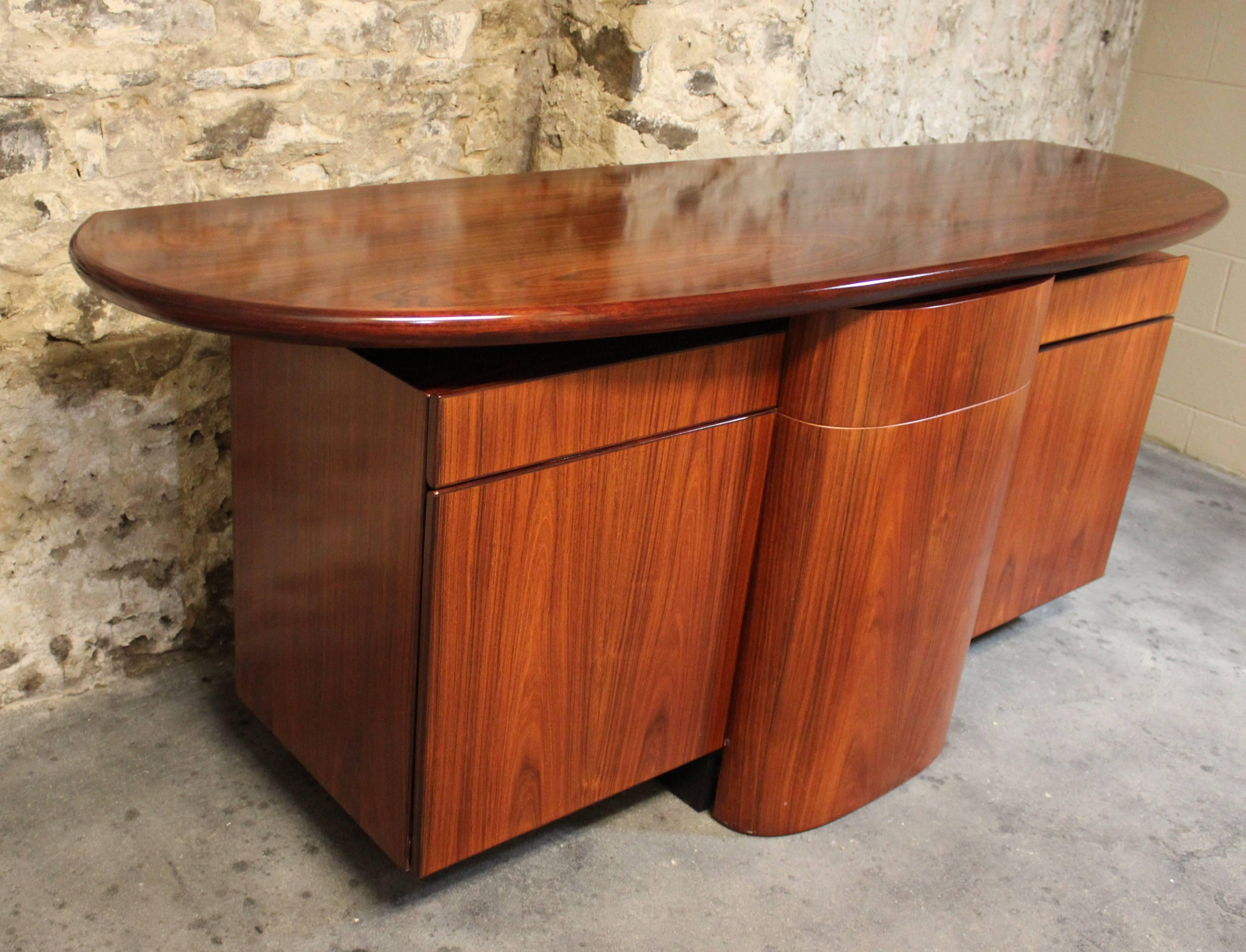 Gorgeous rosewood sideboard by Skovby Mobelfabrik. The stunning Brazilian rosewood throughout is in fantastic condition. This unit features a sleek design with plenty of storage space. What's unique about this credenza is that the center piece is