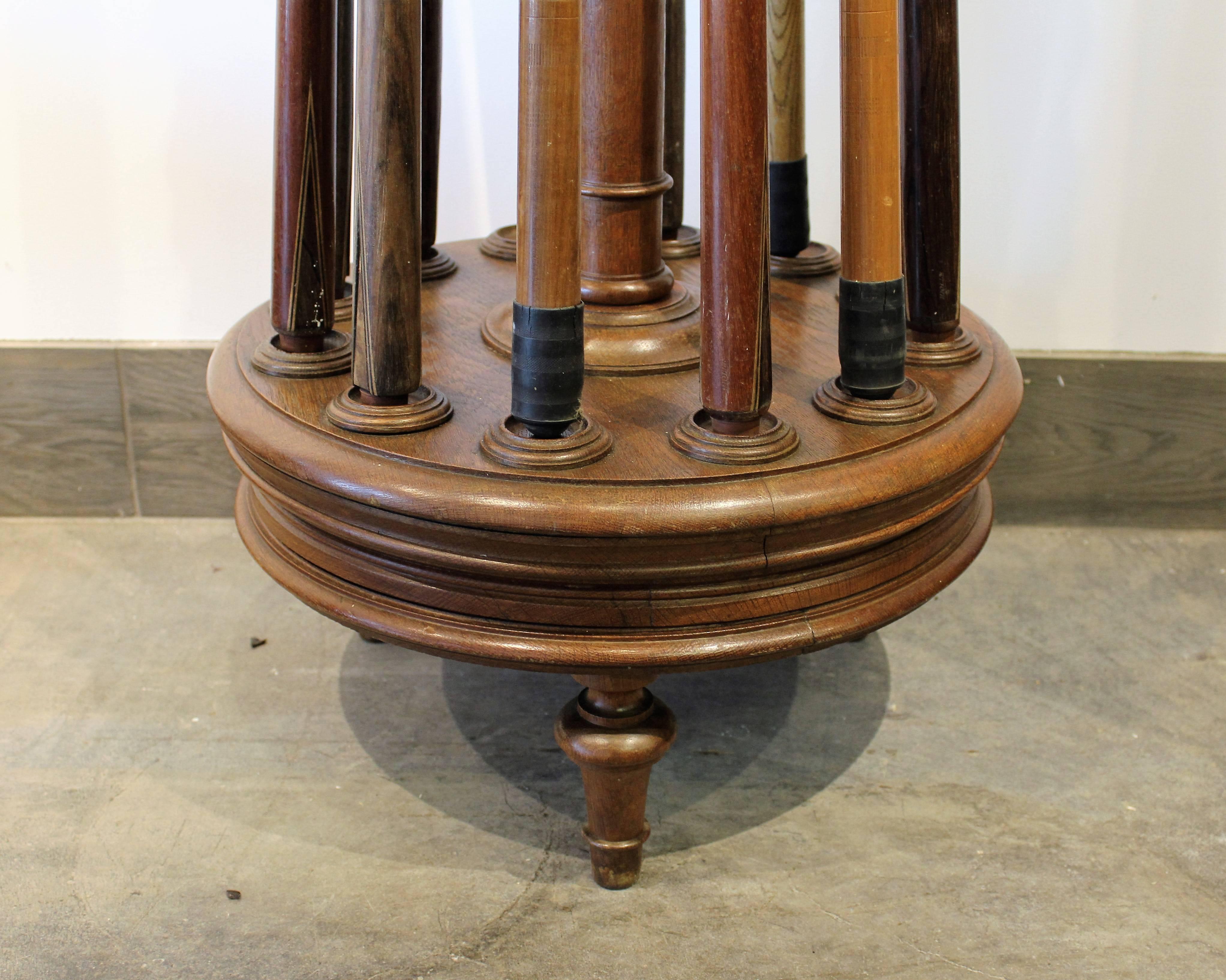 This elegant French cue rack has a tall central column with shaped top and is raised on shaped feet. This set comes with 11 pool cues while the stand will hold 12 cues. A very unique games room piece.