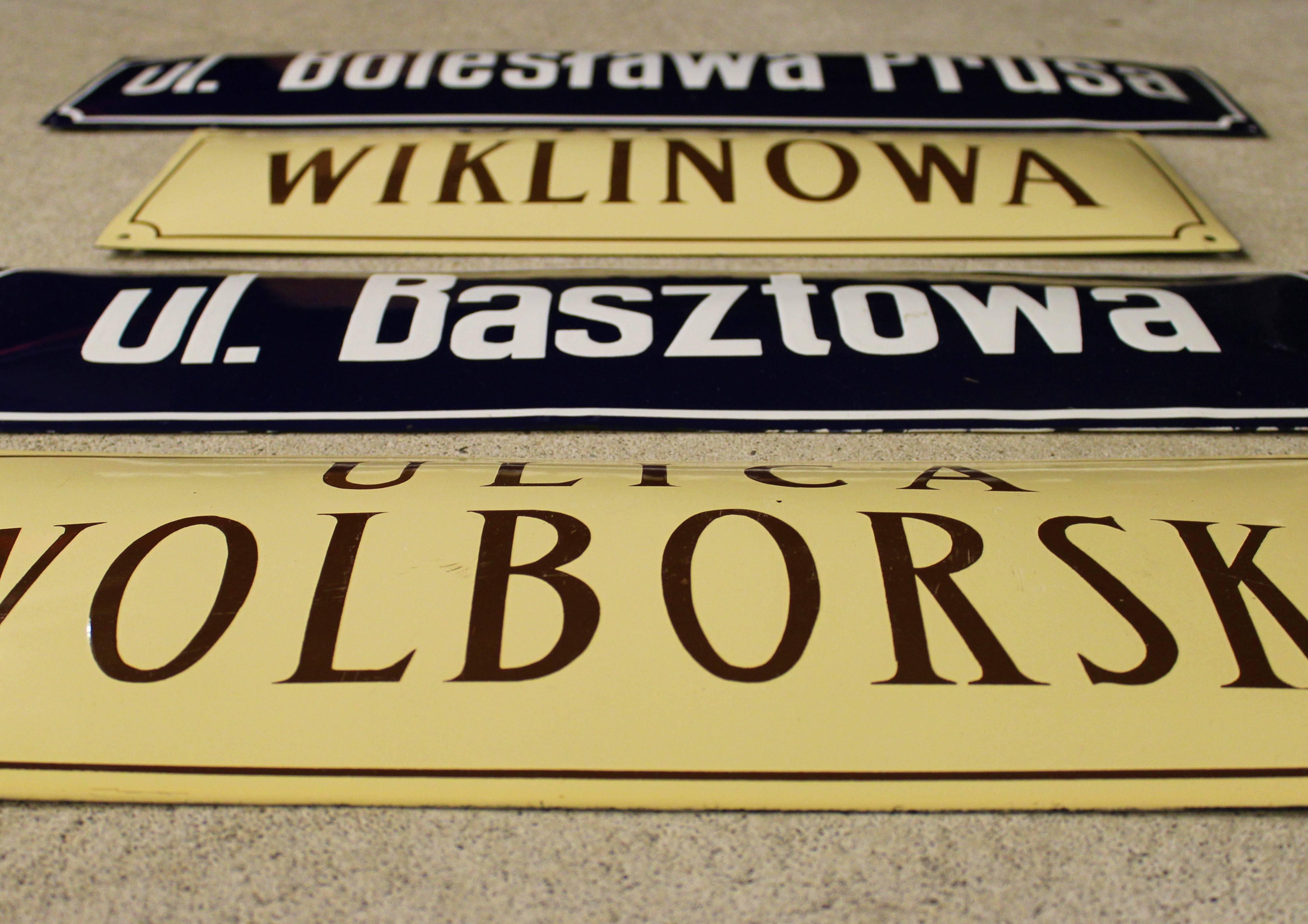 Porcelain convex street signs from Warsaw, Poland.