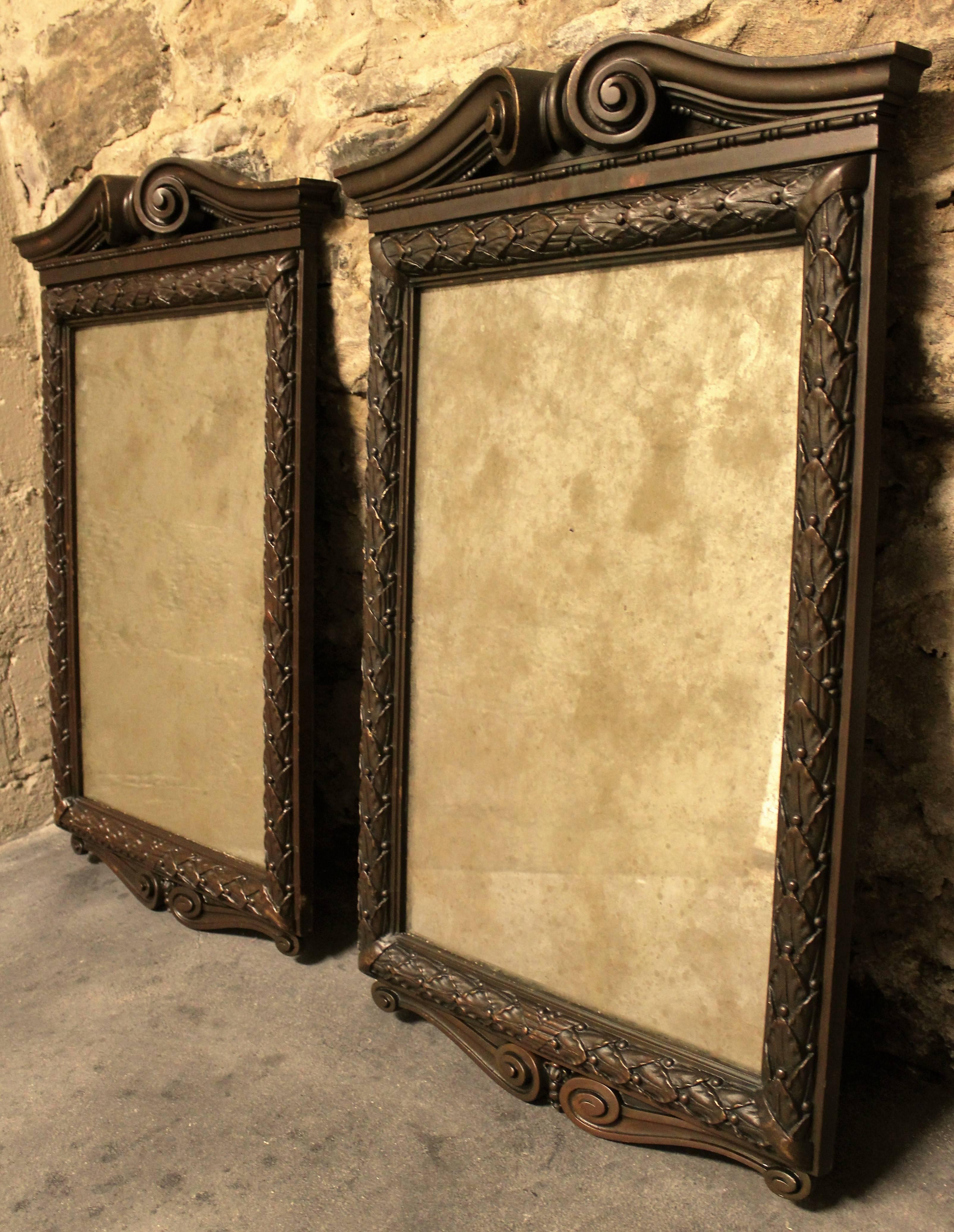 Pair of solid bronze neoclassical mirrors.