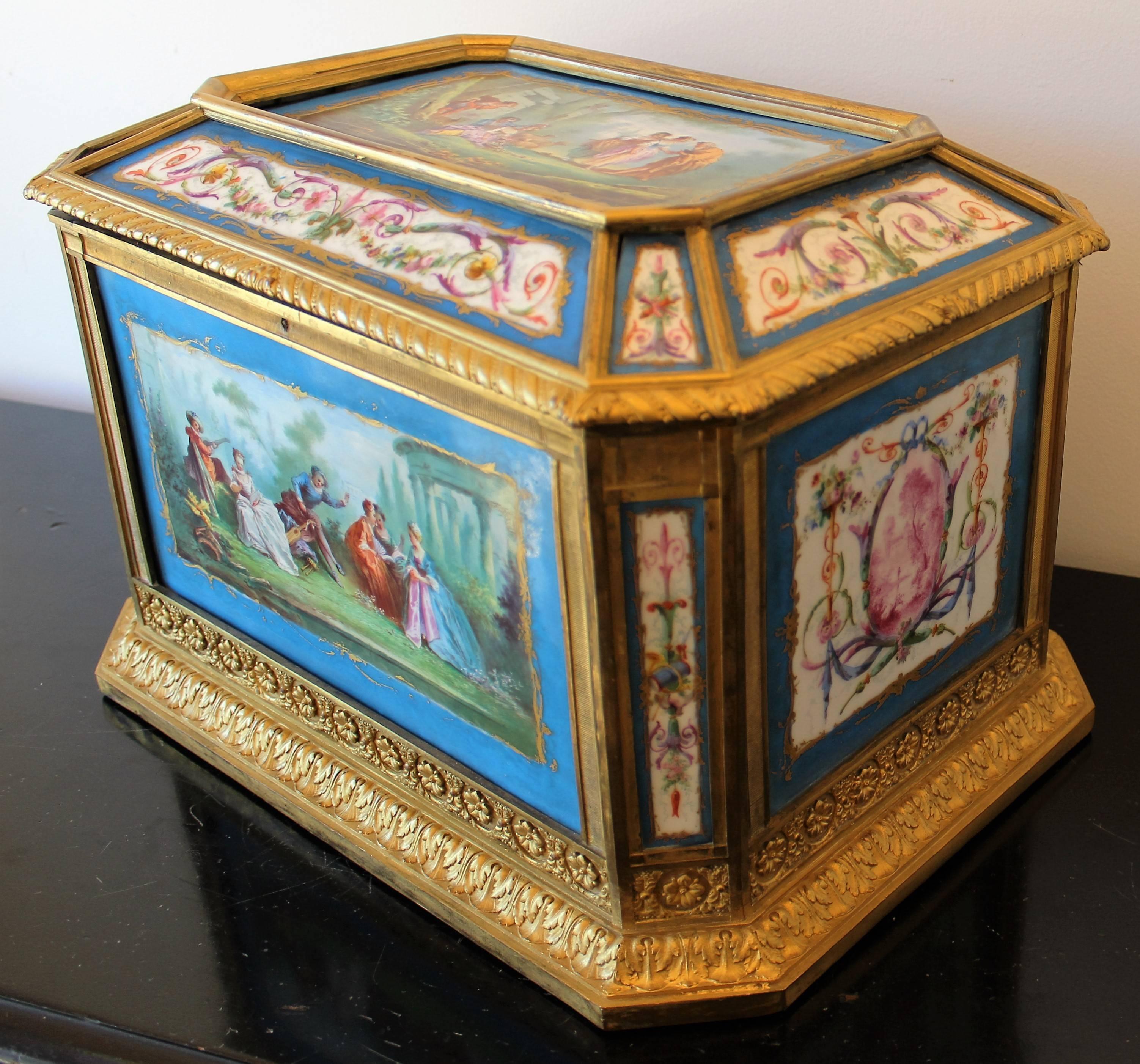 A French Sevres style porcelain casket with gilt bronze mounts. This piece features seventeen hand-painted porcelain plaques within a stunning gilt bronze framework.