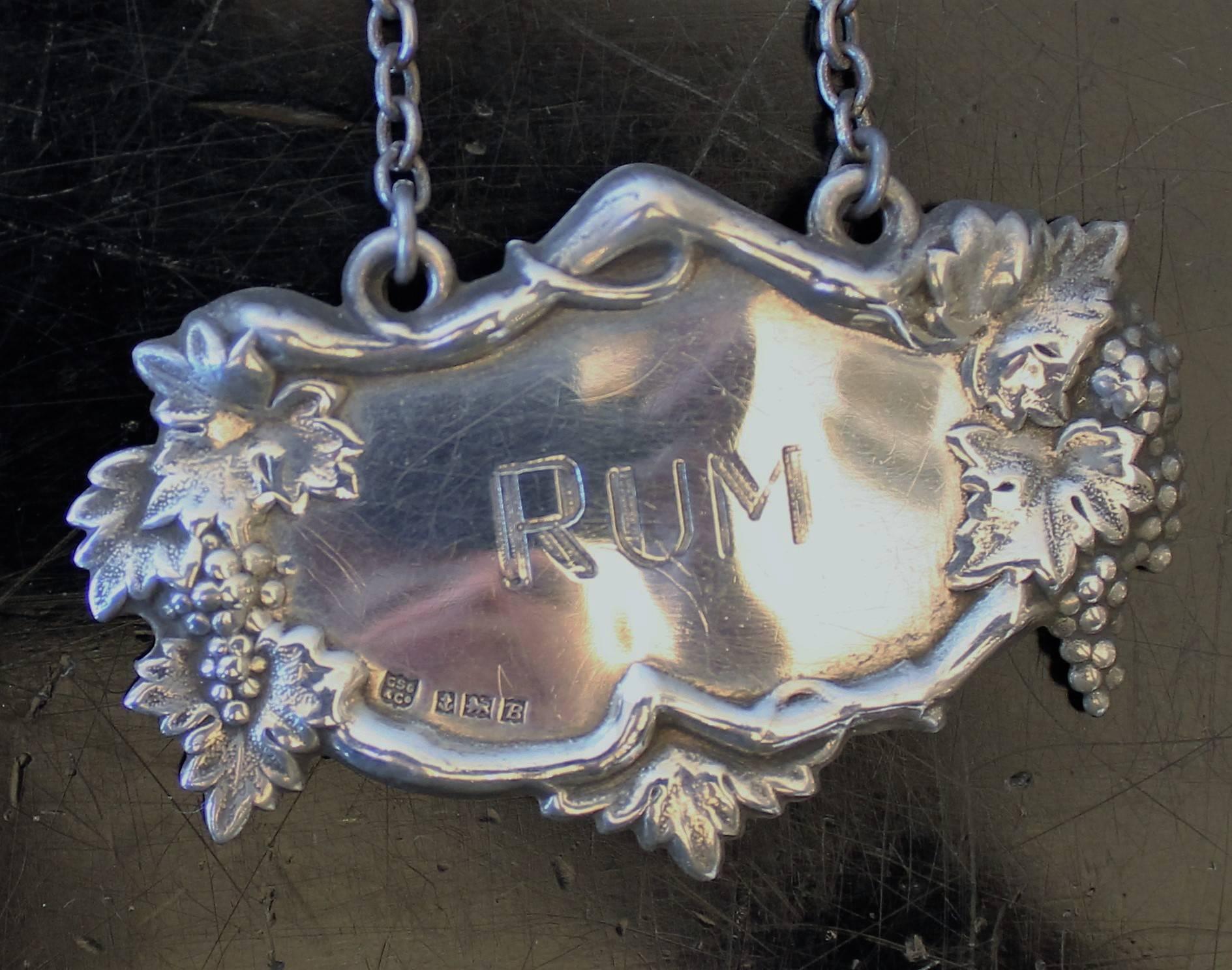 Set of five sterling silver liquor decanter labels: Rum, Rye, Scotch, Gin, Sherry.