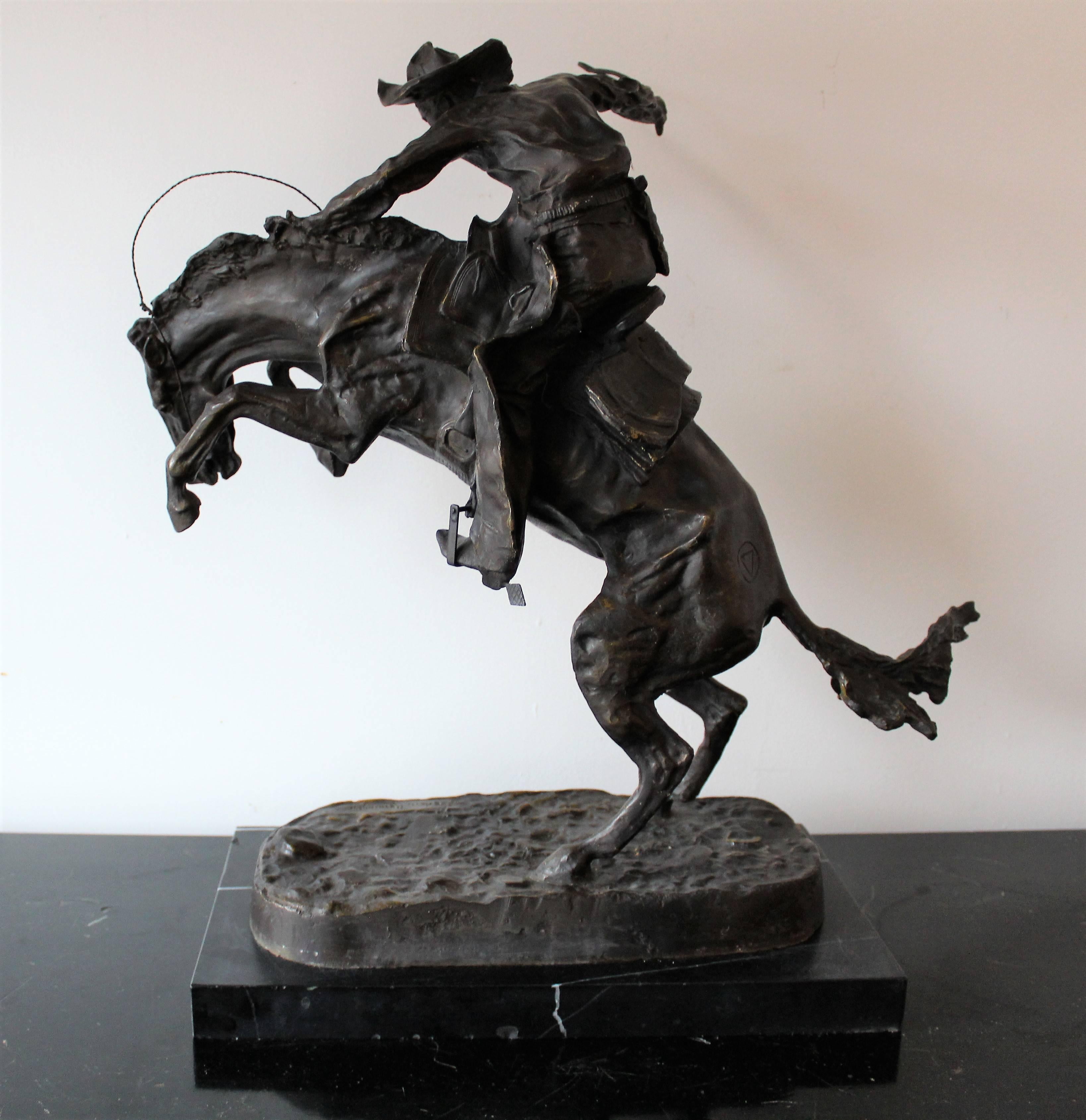 Well executed mid-20th century bronze recast sculpture of Frederic Remington's 'Bronco Buster' on marble plinth.