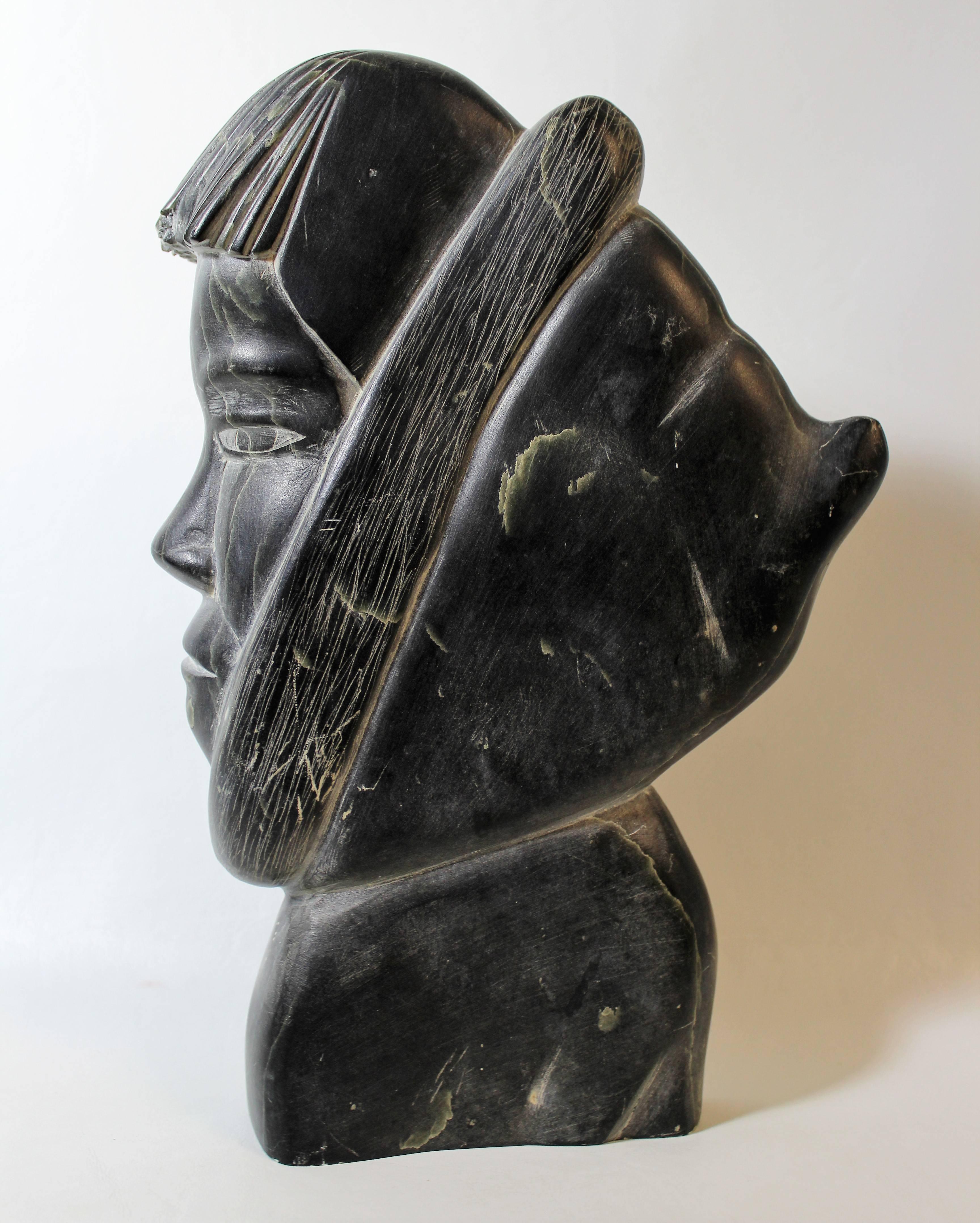 Inuit soapstone carving of Eskimo in parka.