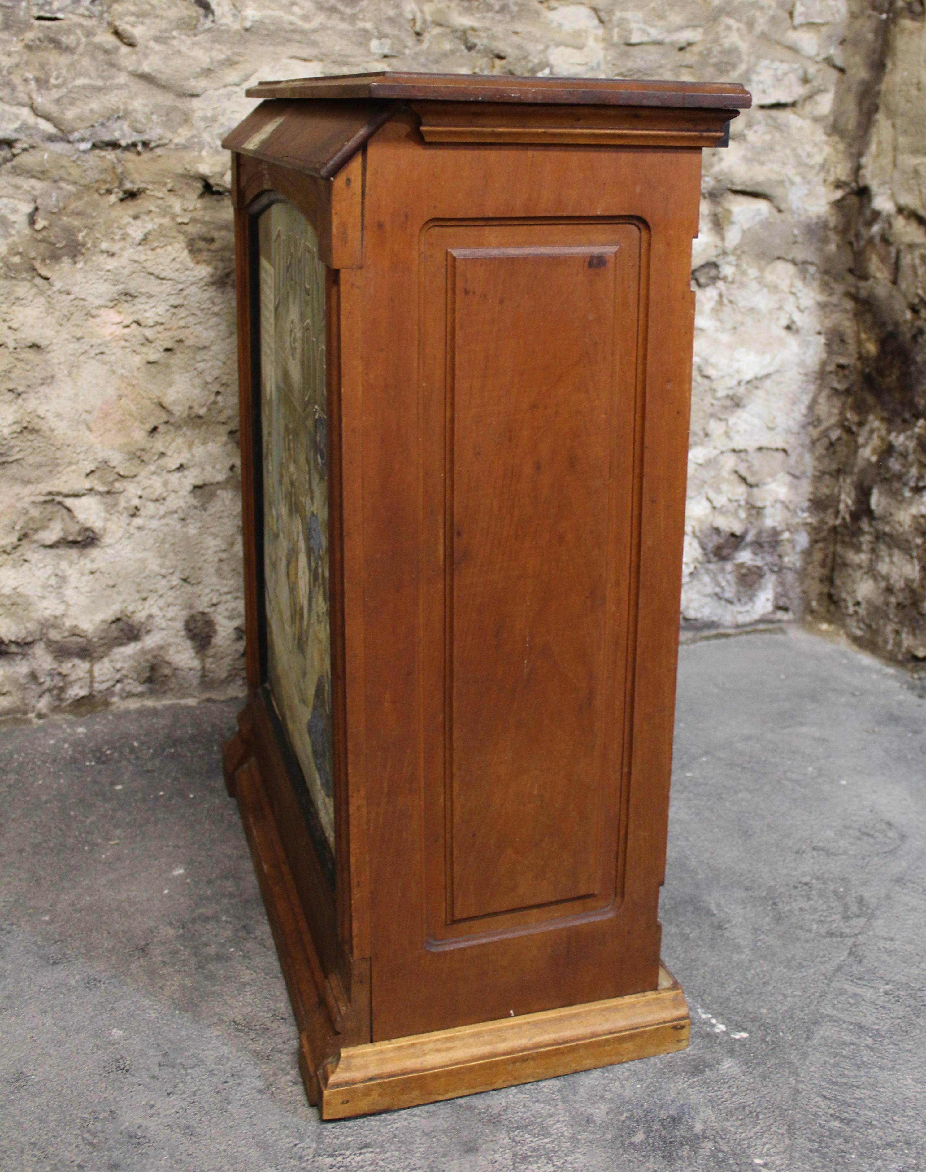 Chromolithograph Diamond Dyes tin panel and birch retail counter cabinet, with slotted interior.