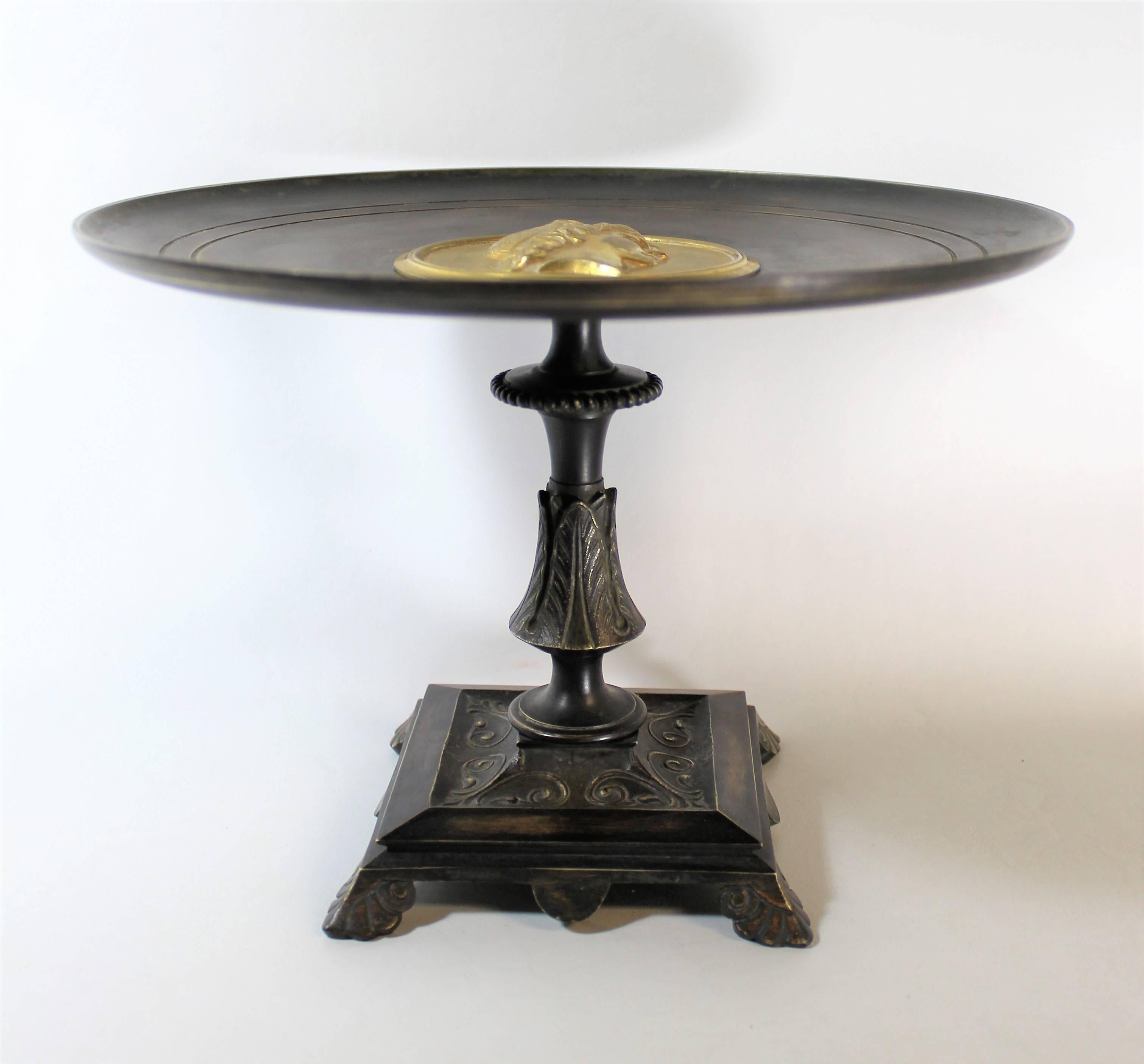 19th century neoclassical style bronze and ebonized tazz with gold gilt medallion.