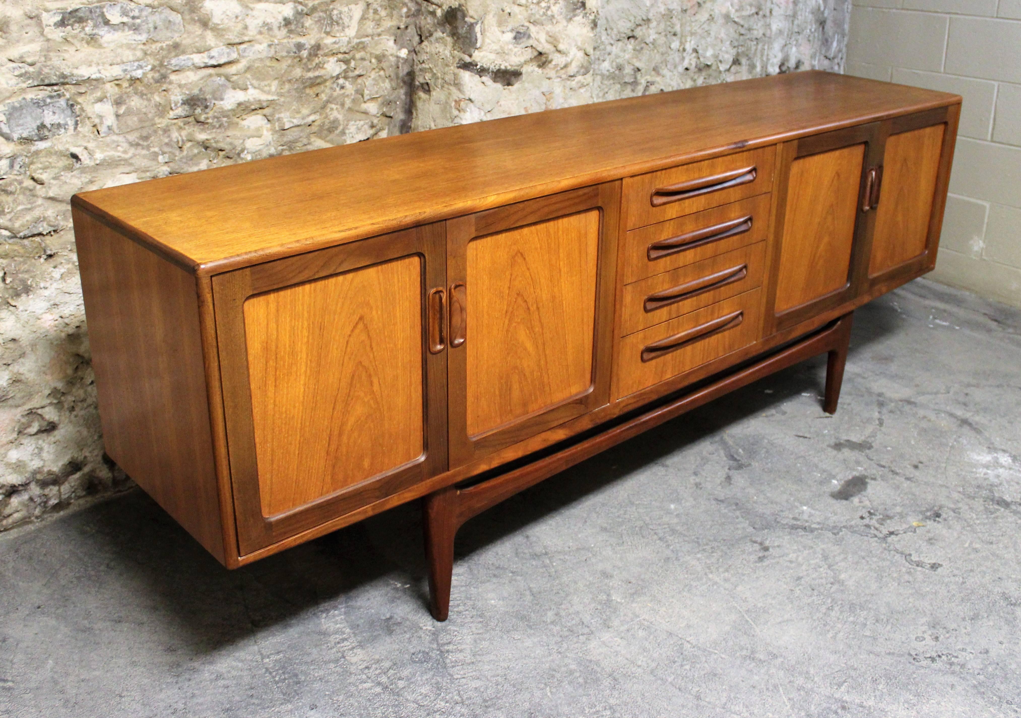 This sideboard (Model Fresco) was designed by Ib Kofod-Larsen and manufactured by G Plan. It is made from two-tone teak and features four doors and four drawers in the middle.

Scandinavian Modern / Mid-Century Modern.