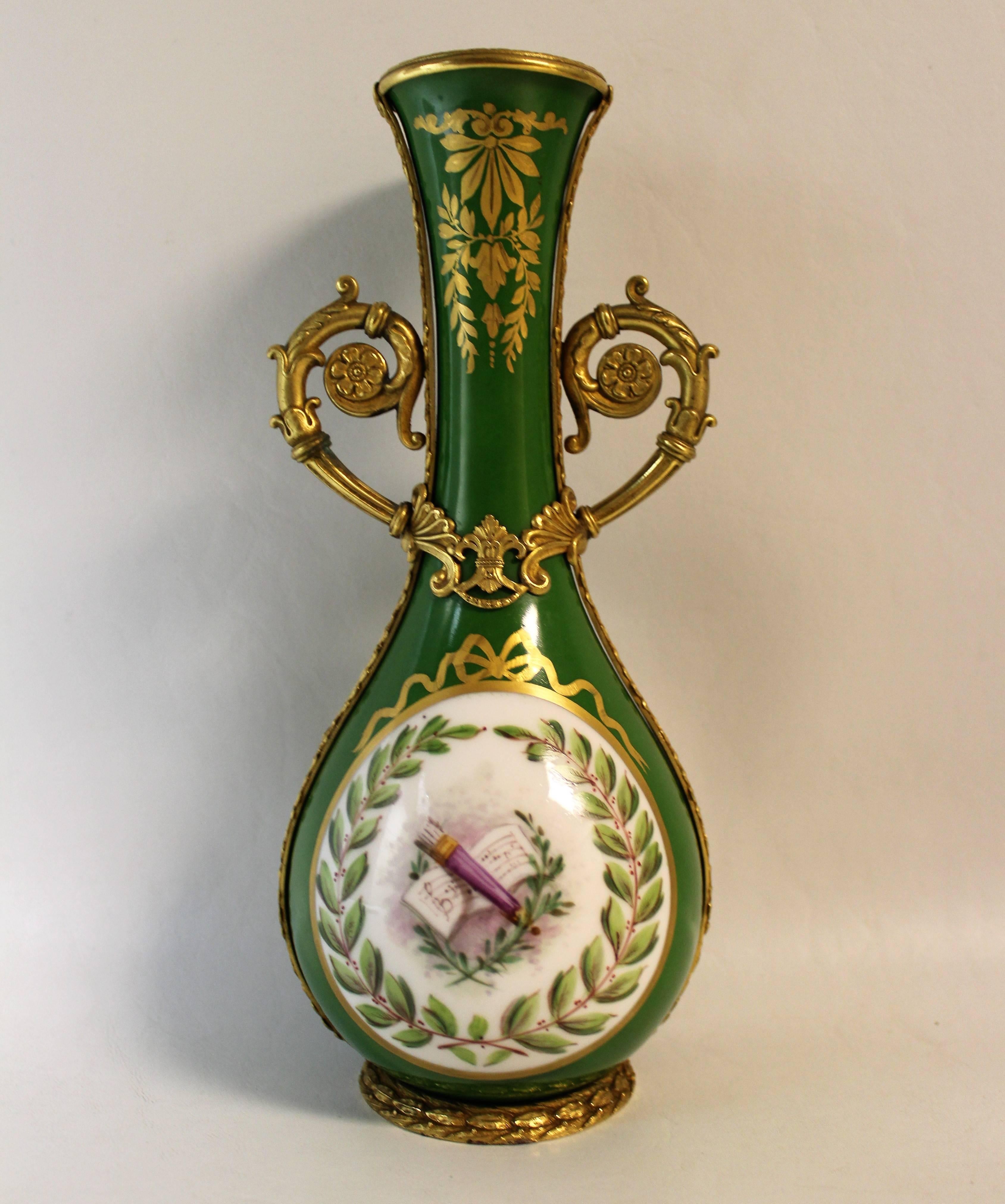 Beautiful 19th century French Sevres attributed ormolu bronze-mounted porcelain vase. The porcelain vase features an all-over mossy green glaze with a round cartouche at the front and back with a laurel wreath and a musical device at the center