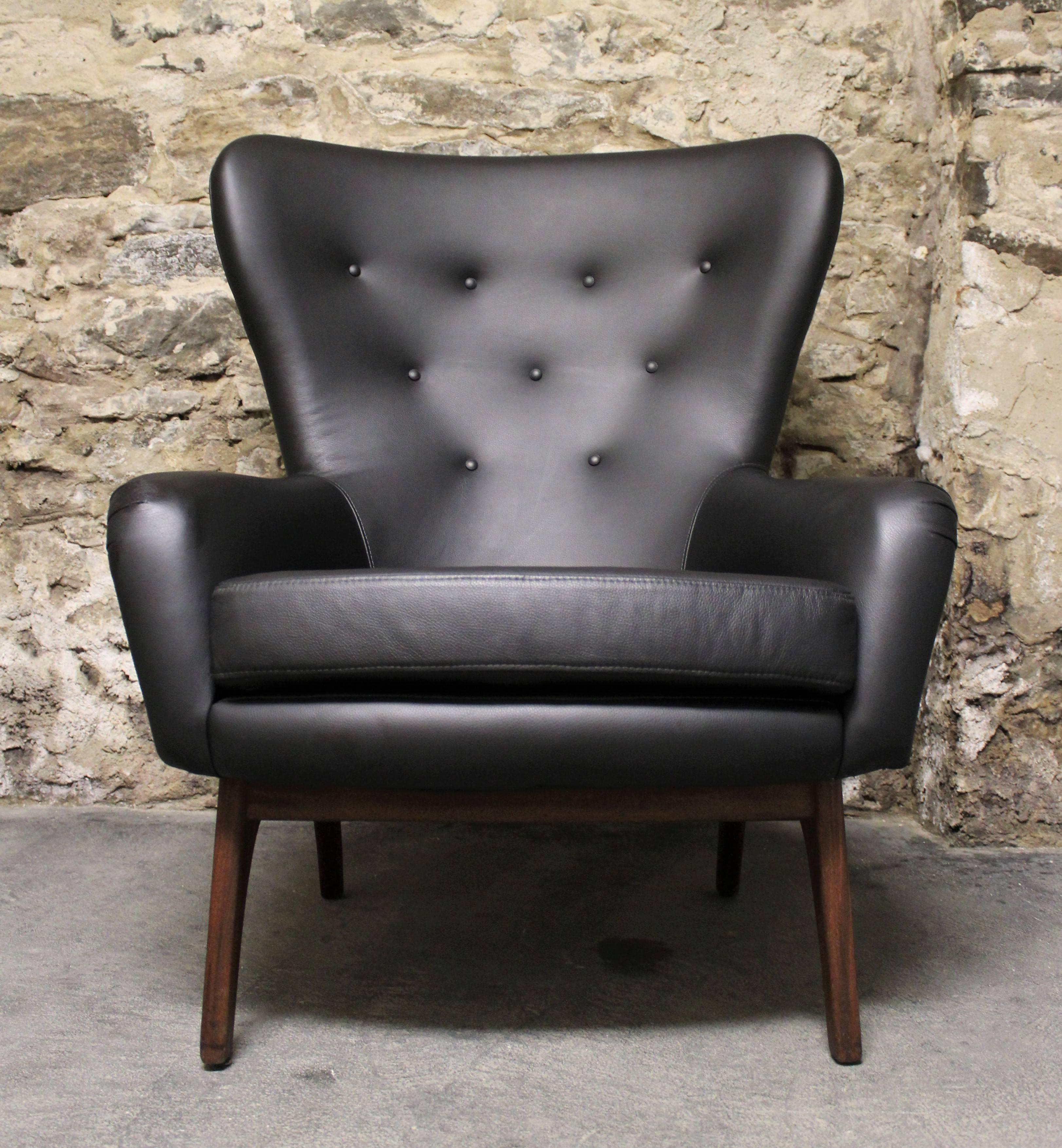 Adrian Pearsall wingback chair with a sculpted walnut frame and re-upholstered in leather.