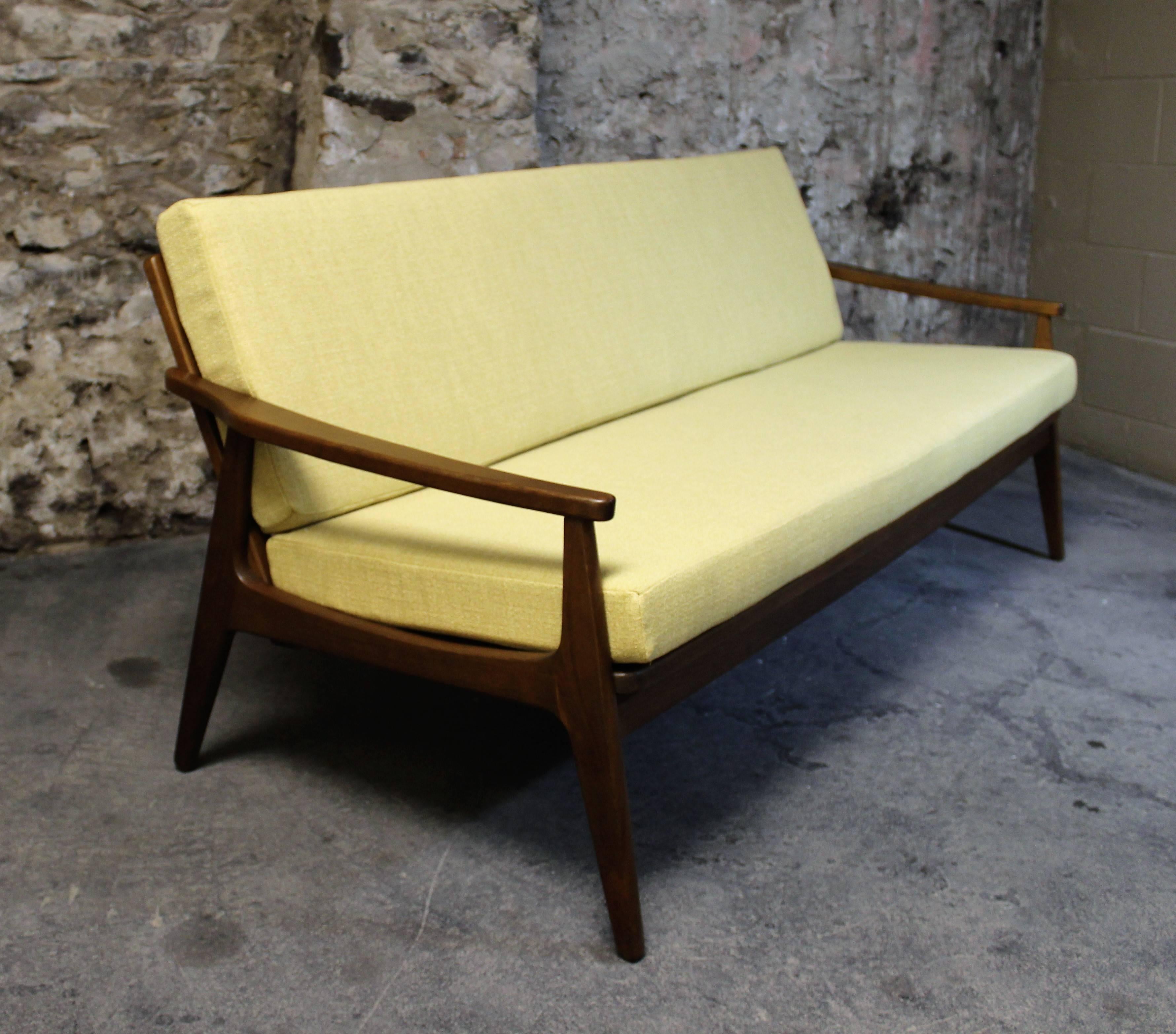 Mid-Century Modern sofa and chair with walnut frame and re-upholstered in yellow fabric.