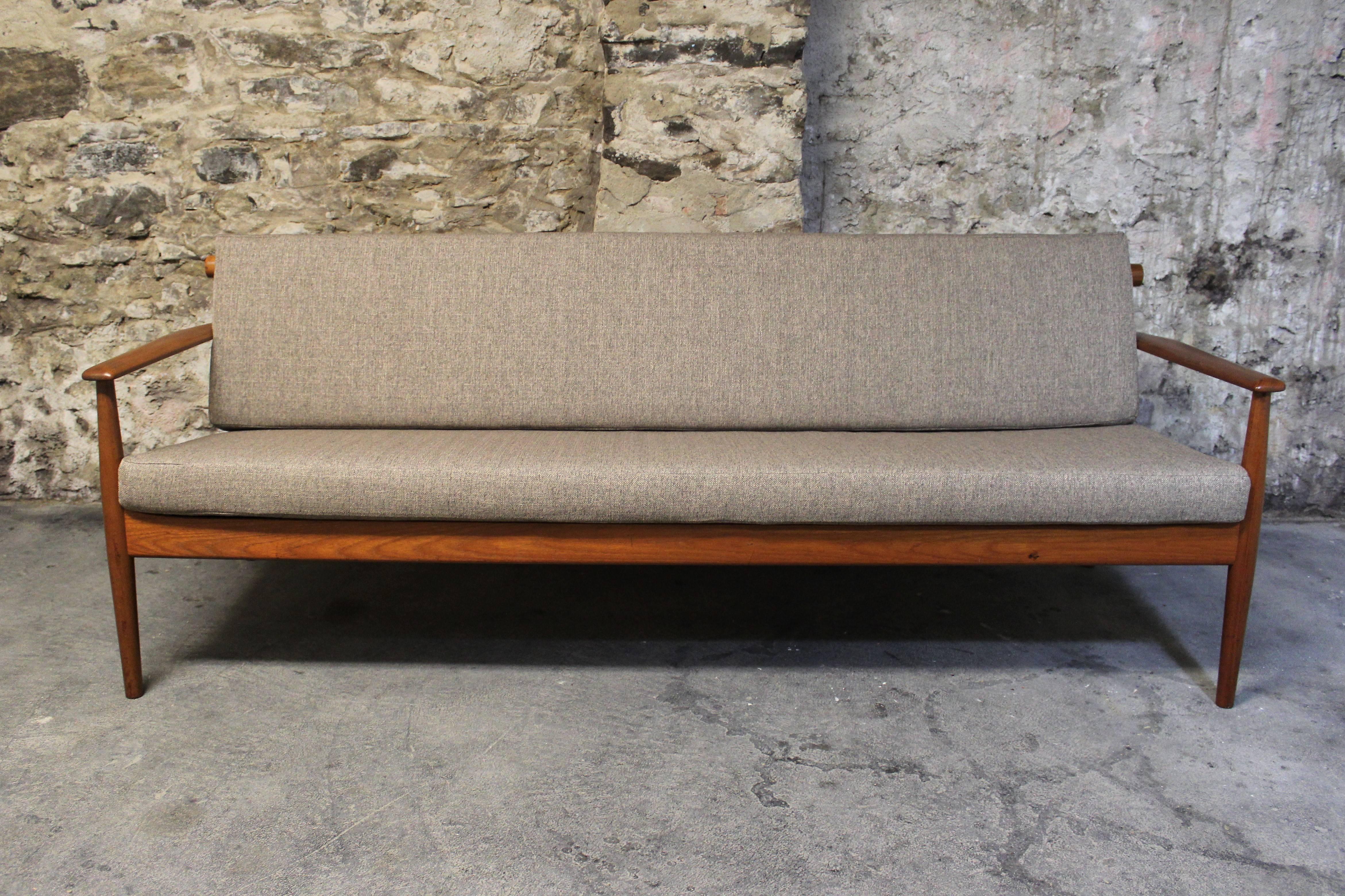 Beautiful Danish modern teak sofa attributed to Grete Jalk. Re-upholstered fabric which has subtle grey/black/taupe tones.

Mid-Century Modern / Scandinavian Modern.