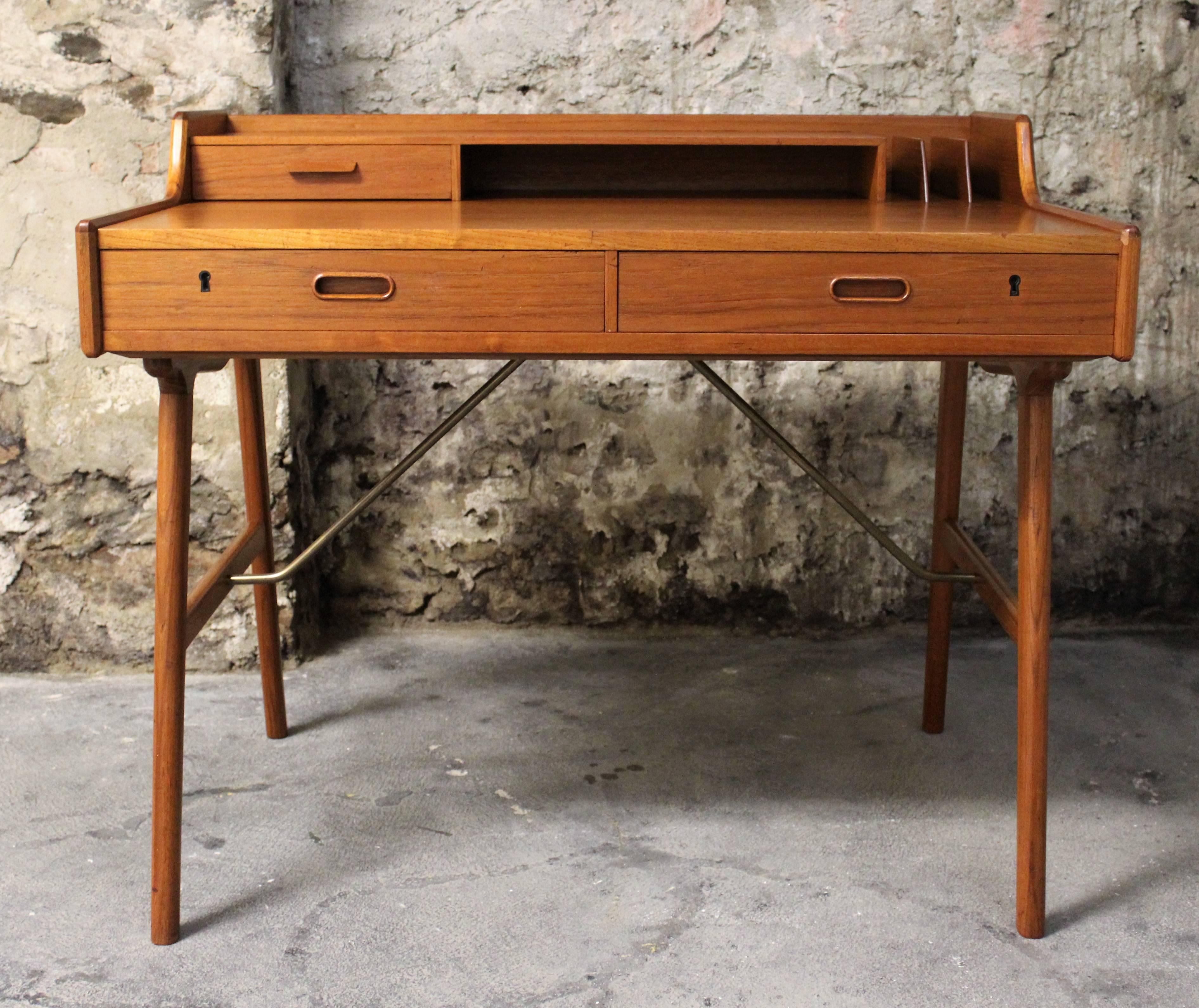 This model no. 56 solid teak desk with splayed legs, tabletop with drawer and storage shelf was designed by Arne Wahl Iversen for Vinde Møbelfabrik in Denmark.

Scandinavian Modern / Mid-Century Modern.