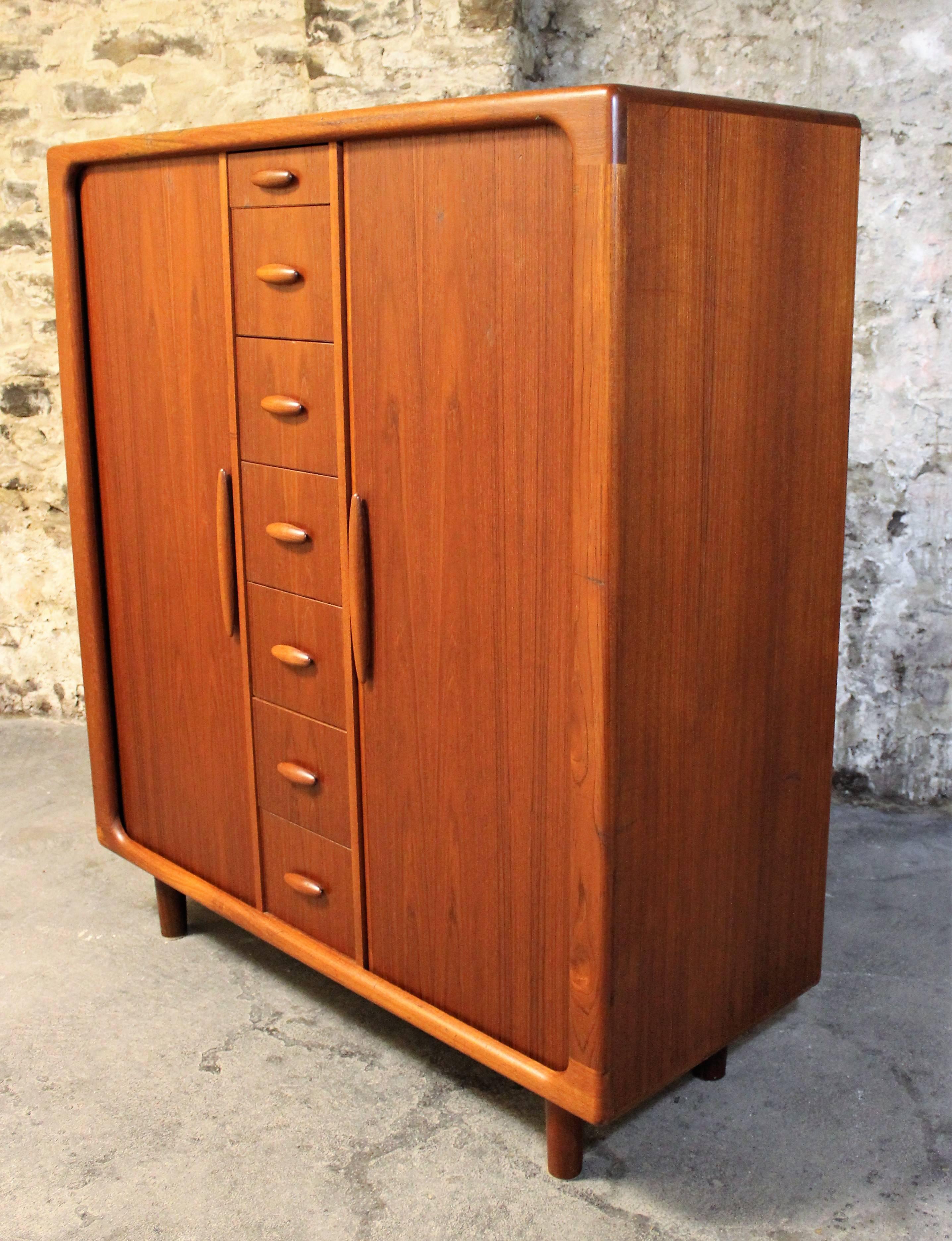 Stunning well-built Danish Modern gentlemen’s chest / dresser in vintage teak by Dyrlund. This chest offers simple graceful lines and heavy construction. It is highly versatile and features an amazing amount of storage space in a small footprint.