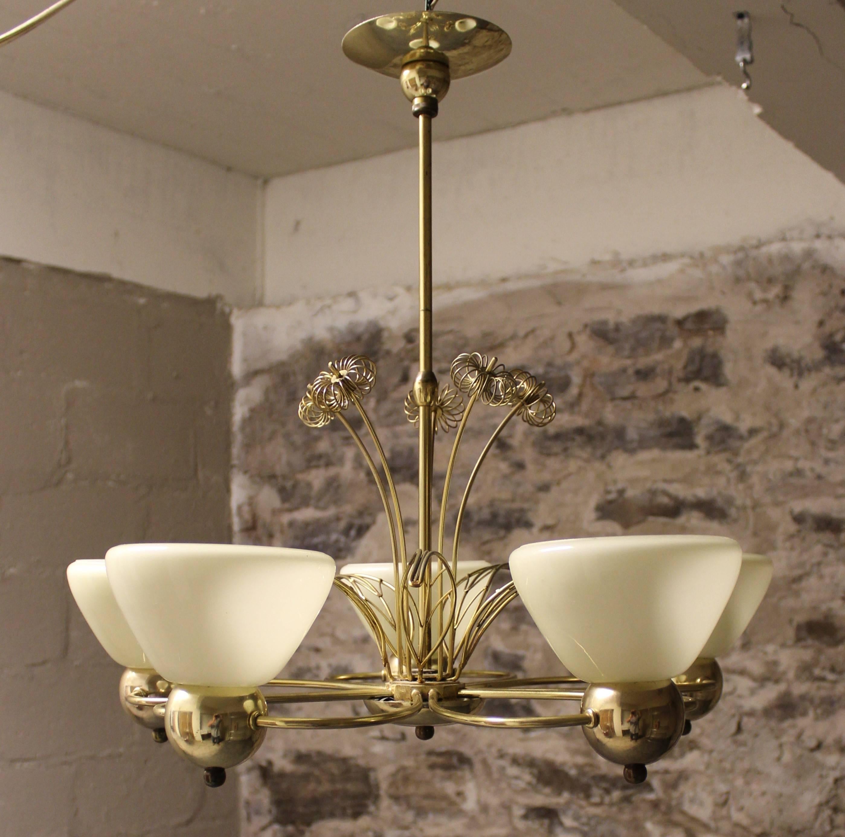 Paavo Tynell five-arm chandelier with brass flowers and leaves emerging from the center.