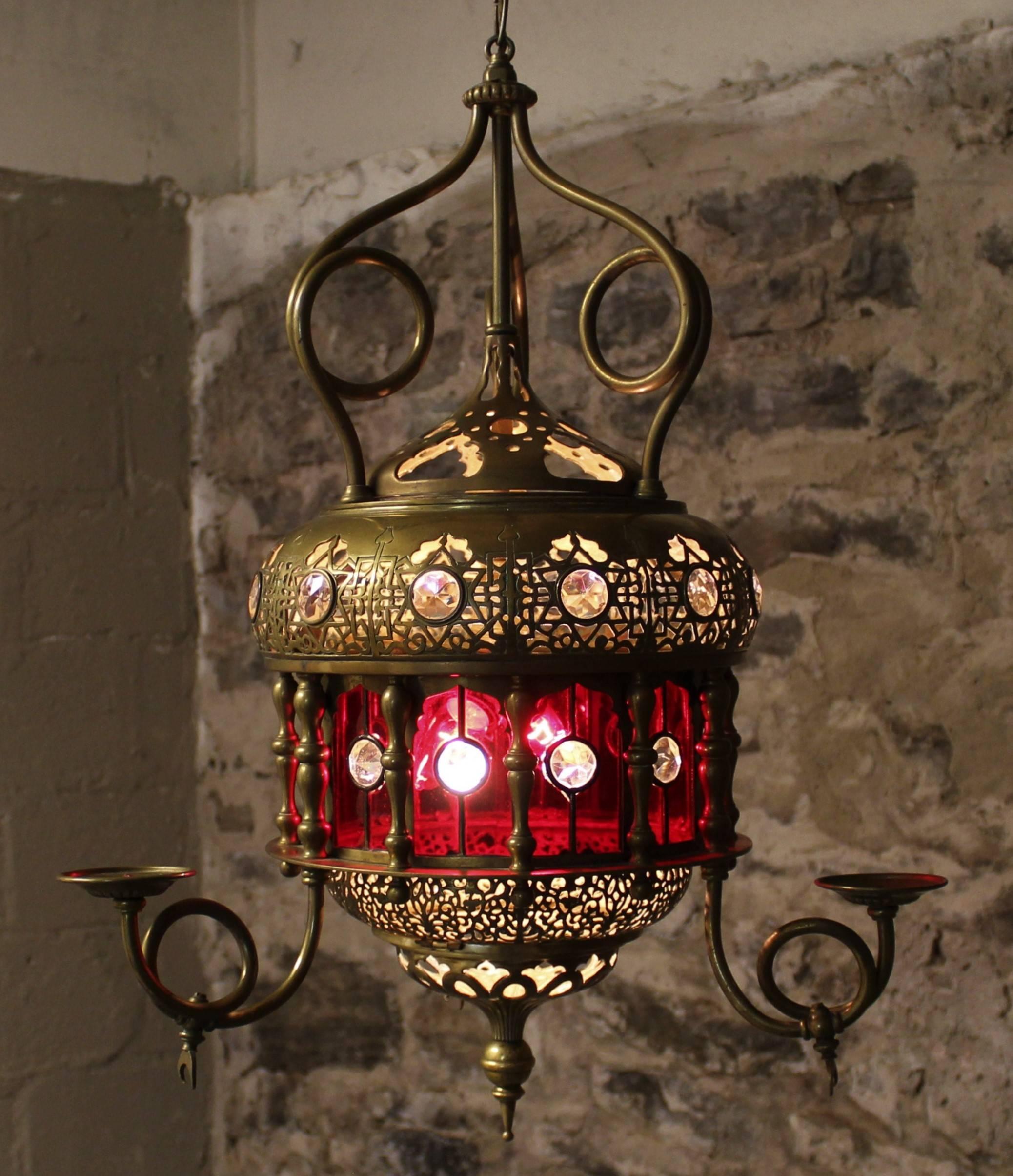 Morroccan lantern with pierced brass and ruby red glass.