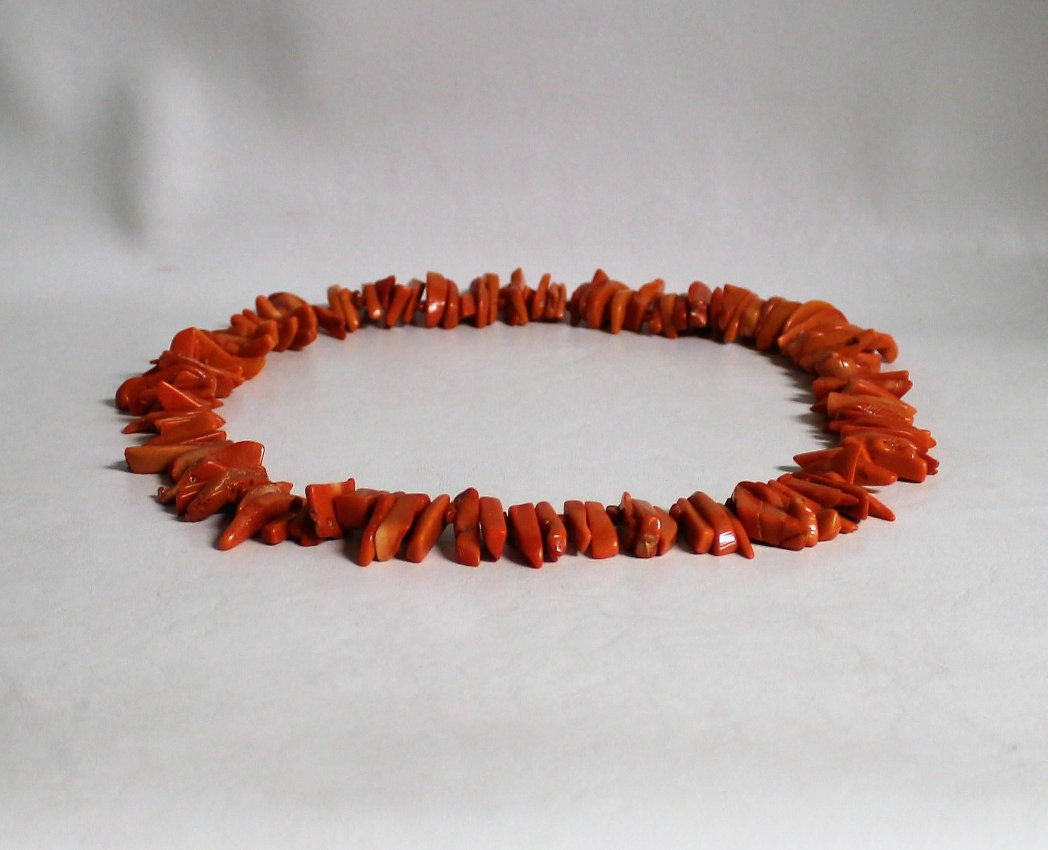 Salmon color coral necklace.
