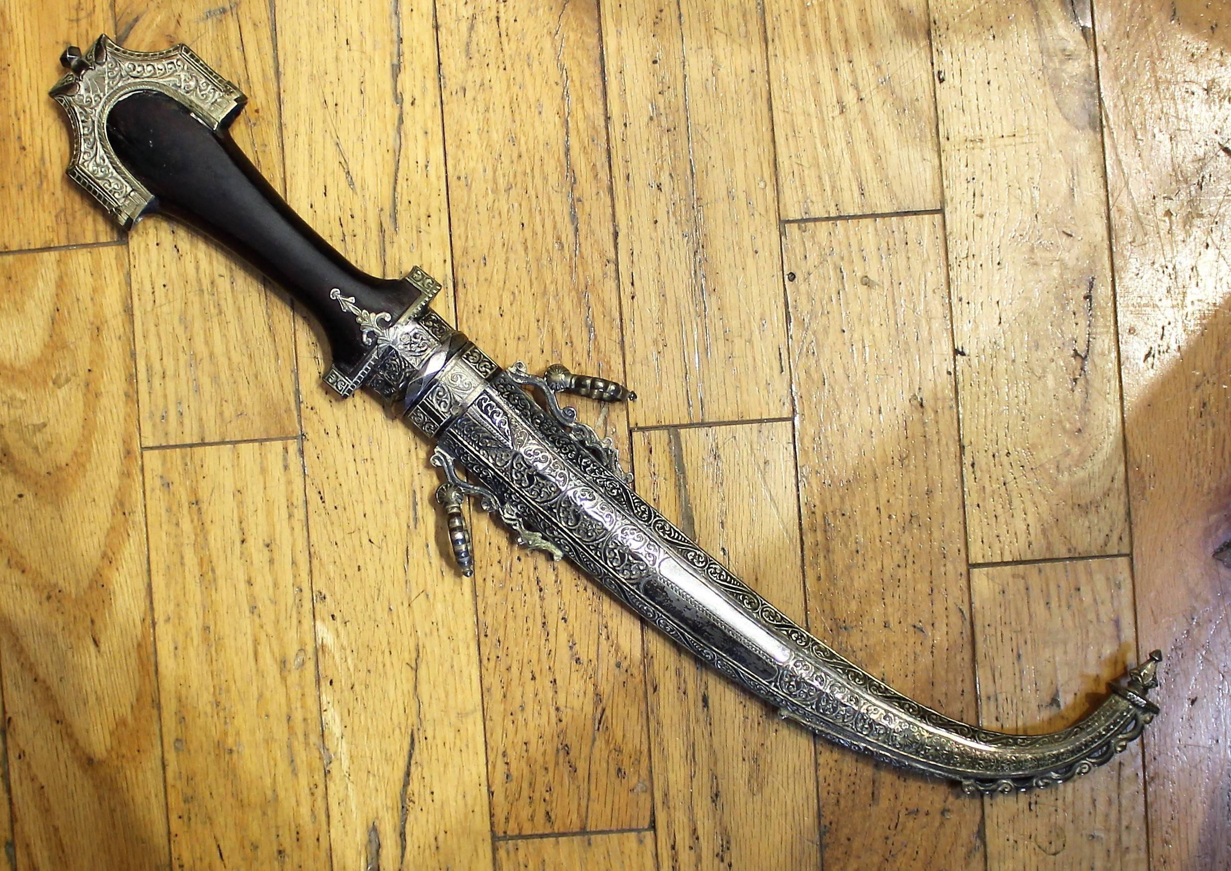 19th century Persian dagger with sheath. Features silver with gold inlay.