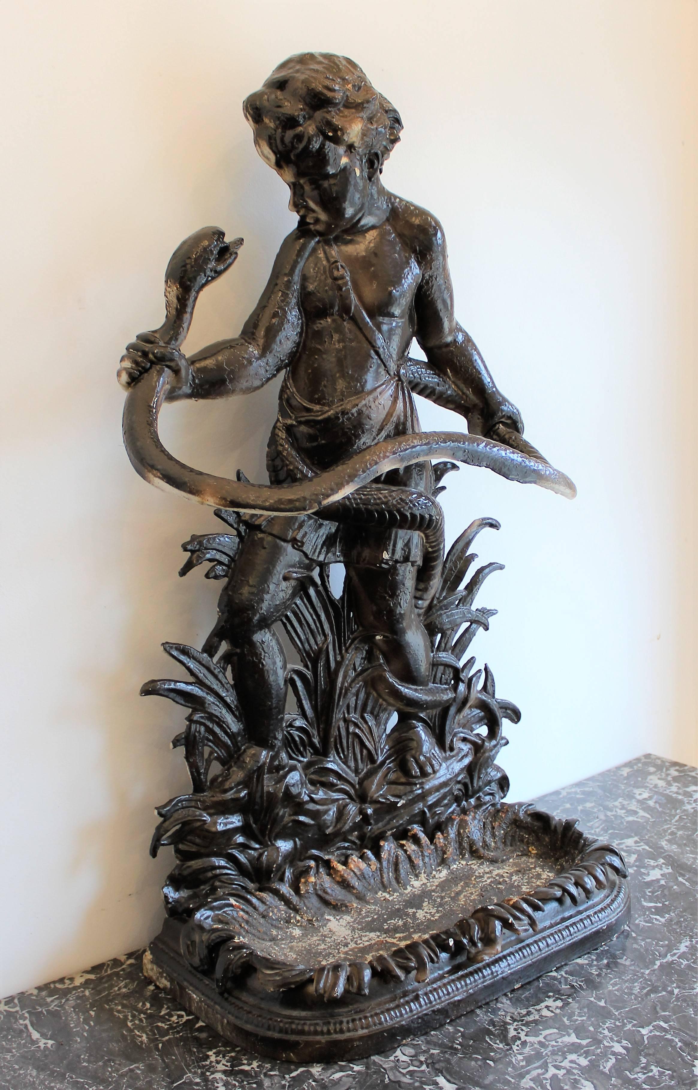 19th century English cast iron painted umbrella stand by Sheffield, Edwin & Theophilus Smith depicting the baby Hercules wrestling with the snake that the jealous Hera sent to destroy the child.