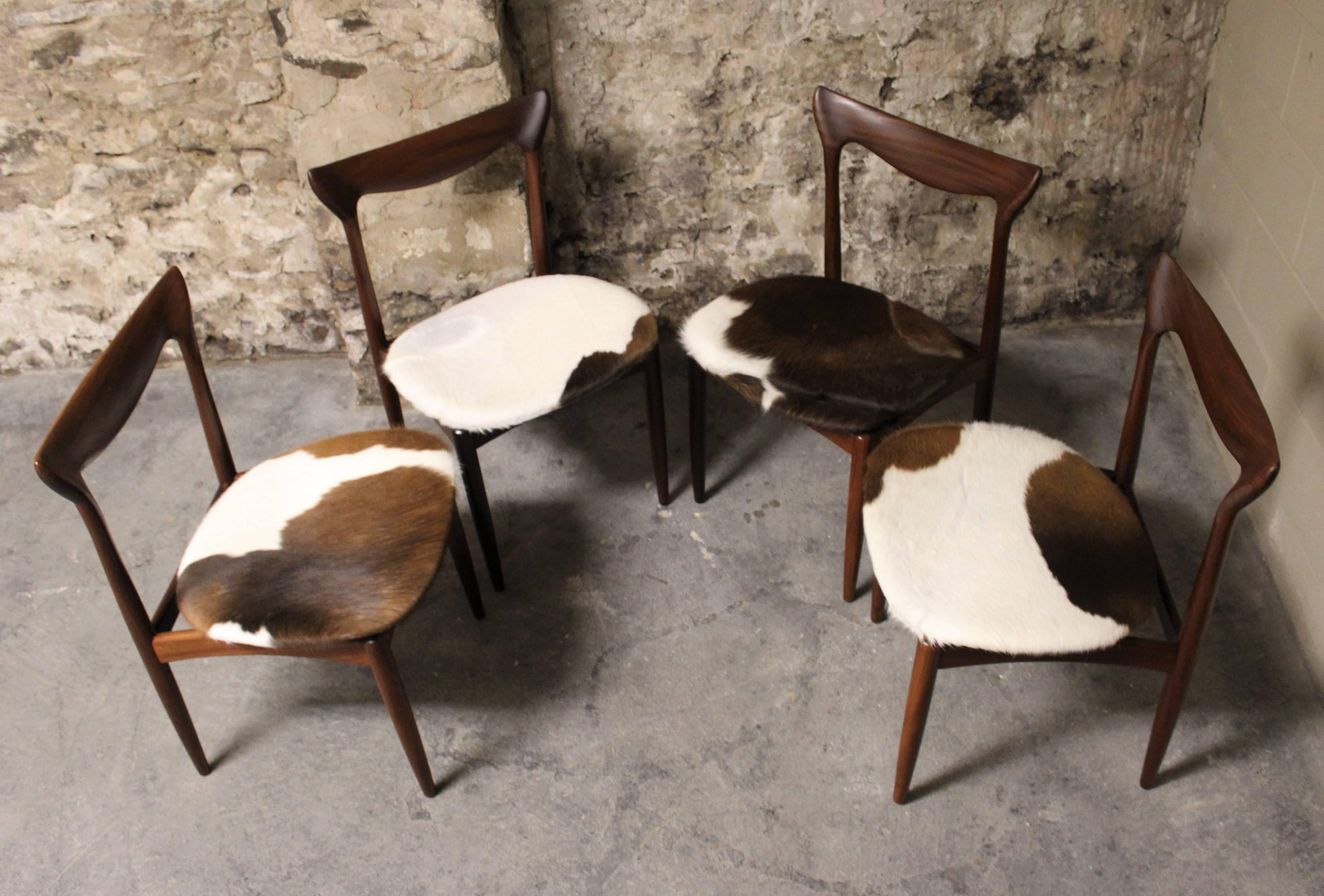 Four H. W. Klein Danish teak dining chairs in cowhide upholstery.

Scandinavian Modern / Mid-Century Modern