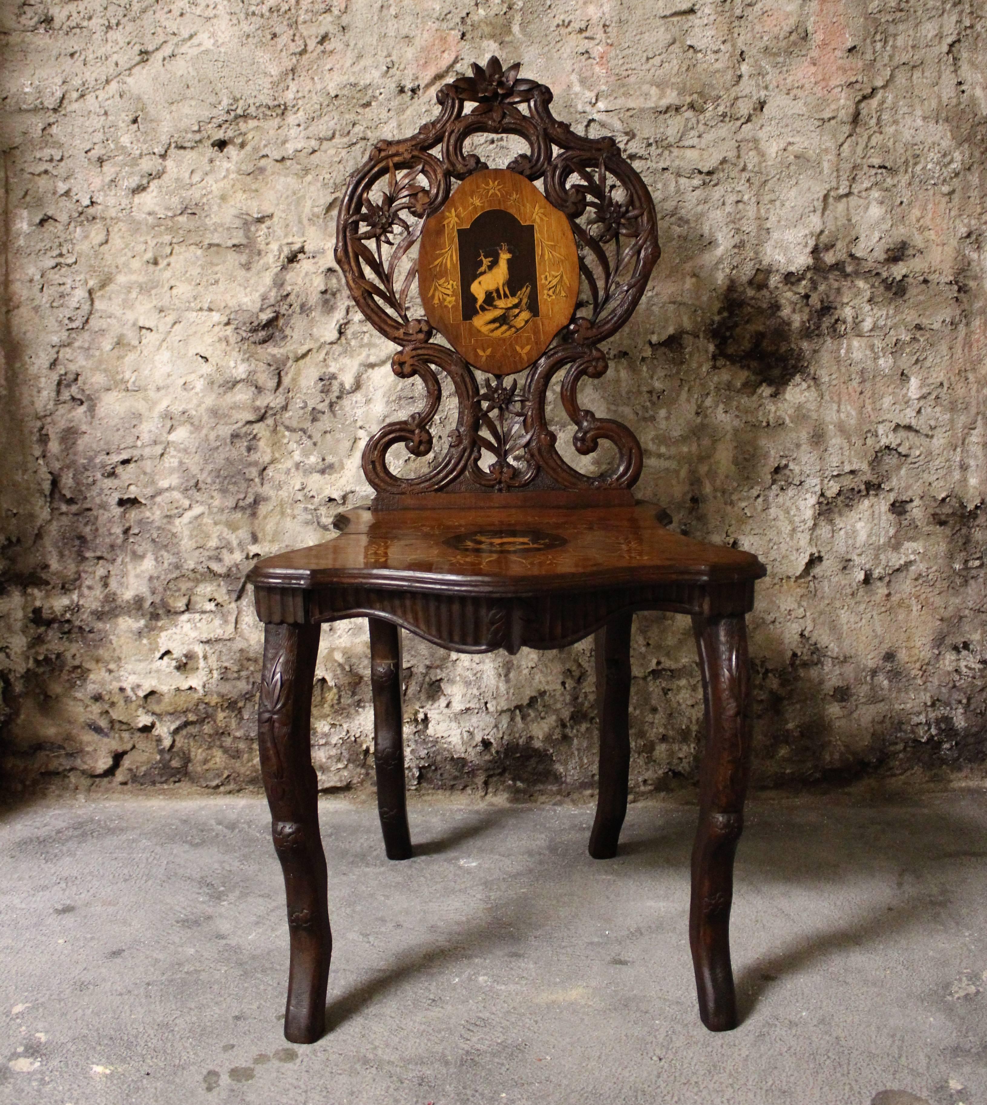 19th century Black Forest carved chair with inlay.