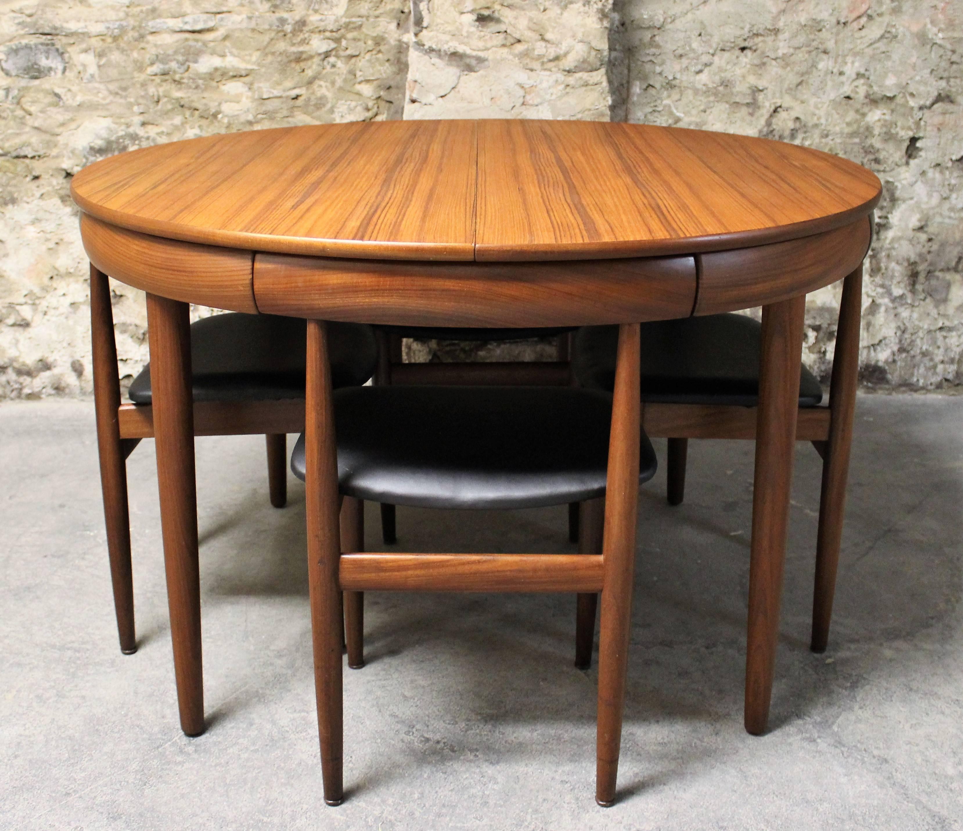 This teak Roundette model dining set, consisting of one extendable dining table and four chairs was designed by Hans Olsen, and manufactured by Frem Rojle in 1952. Made from teak, the table can be extended with a built in butterfly leaf. The