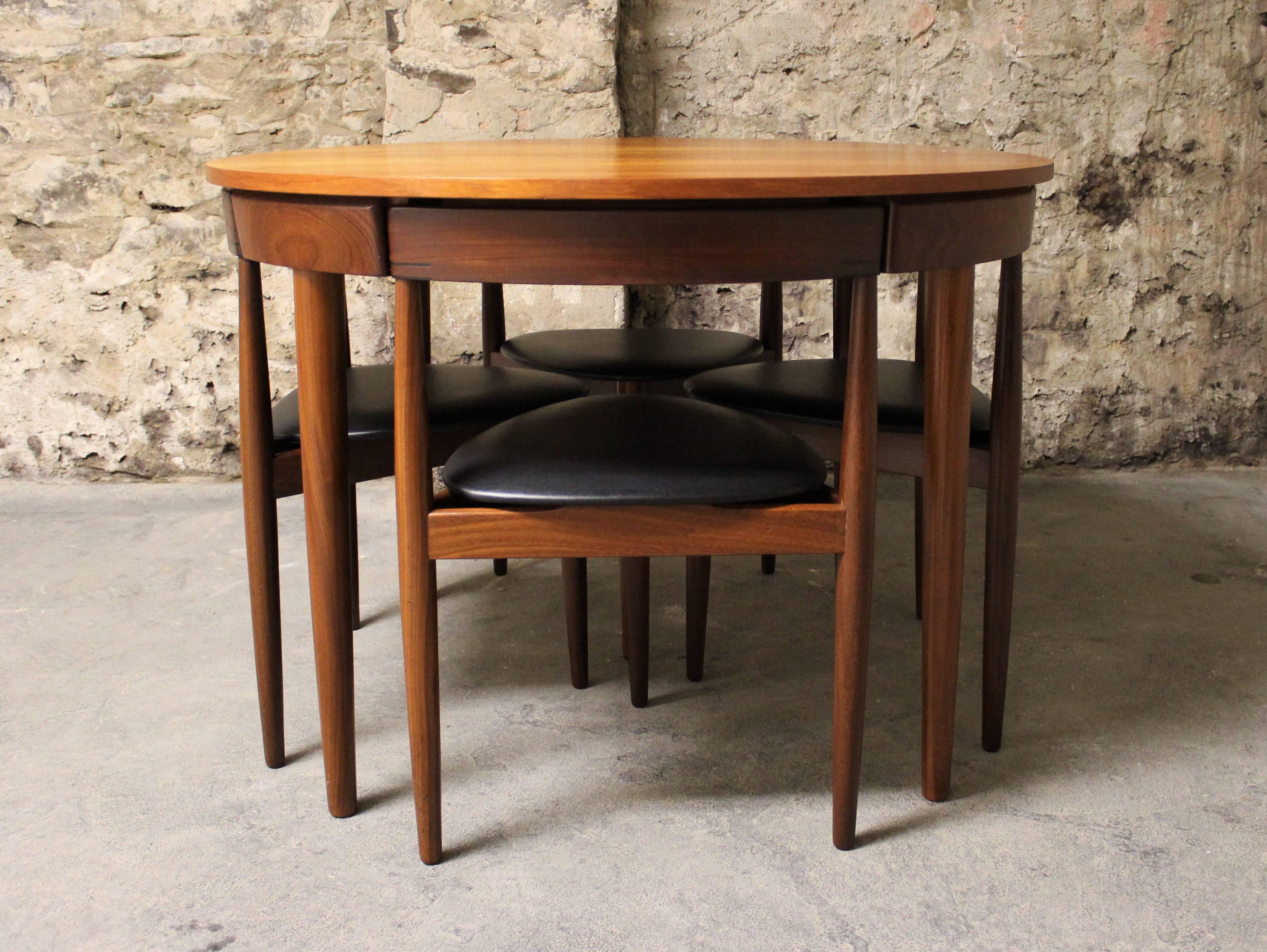 This teak Roundette model dining set, consisting of one extendable dining table and four chairs was designed by Hans Olsen, and manufactured by Frem Rojle in 1952. Made from teak, the table can be extended with a built in butterfly leaf. The