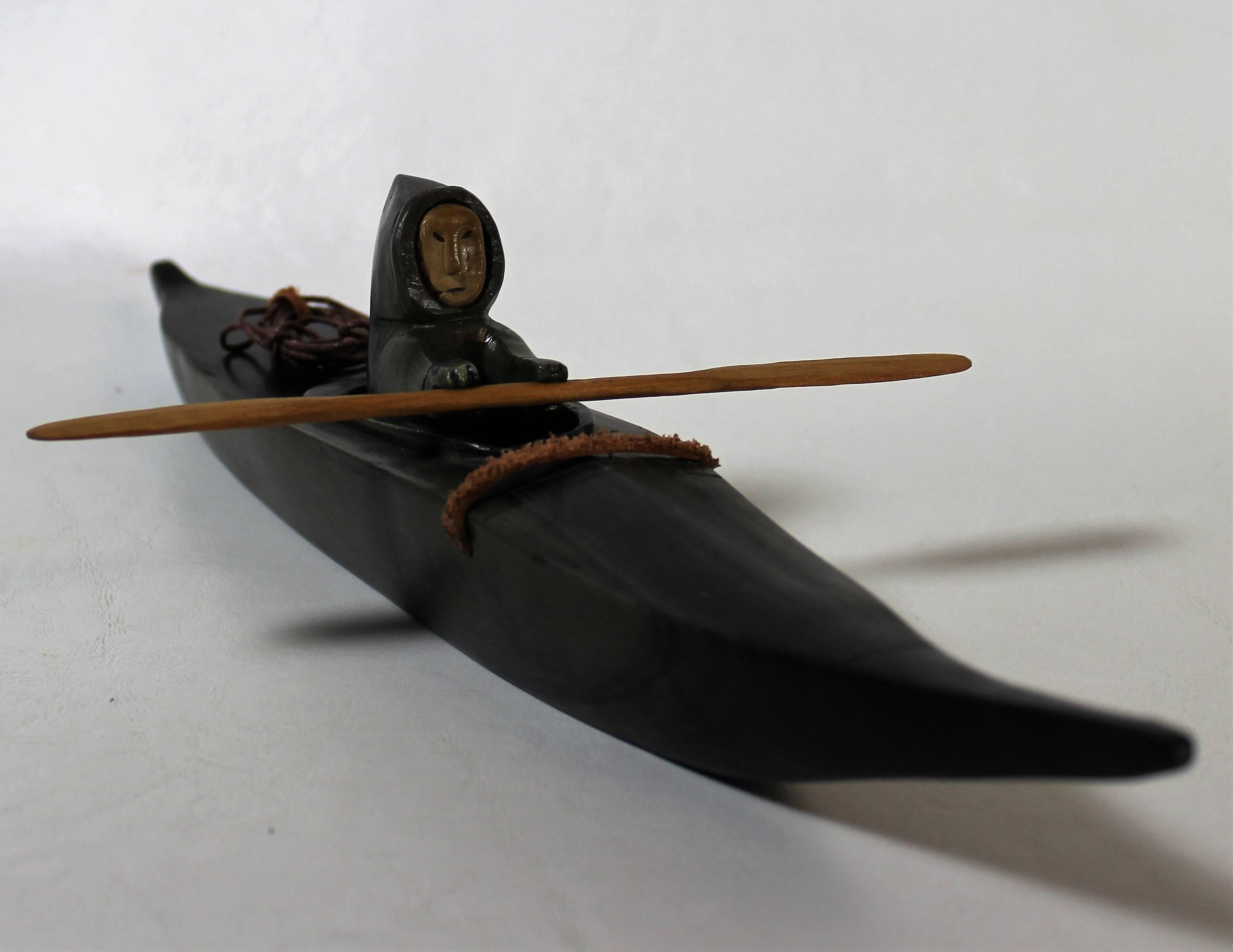 Soapstone and bone sculpture of an Inuit hunter travelling by kayak.

Kayaks are a technology that have a long history of use in the Arctic; they were an important part of subsistence and livelihood for nearly every Inuit group, and their close